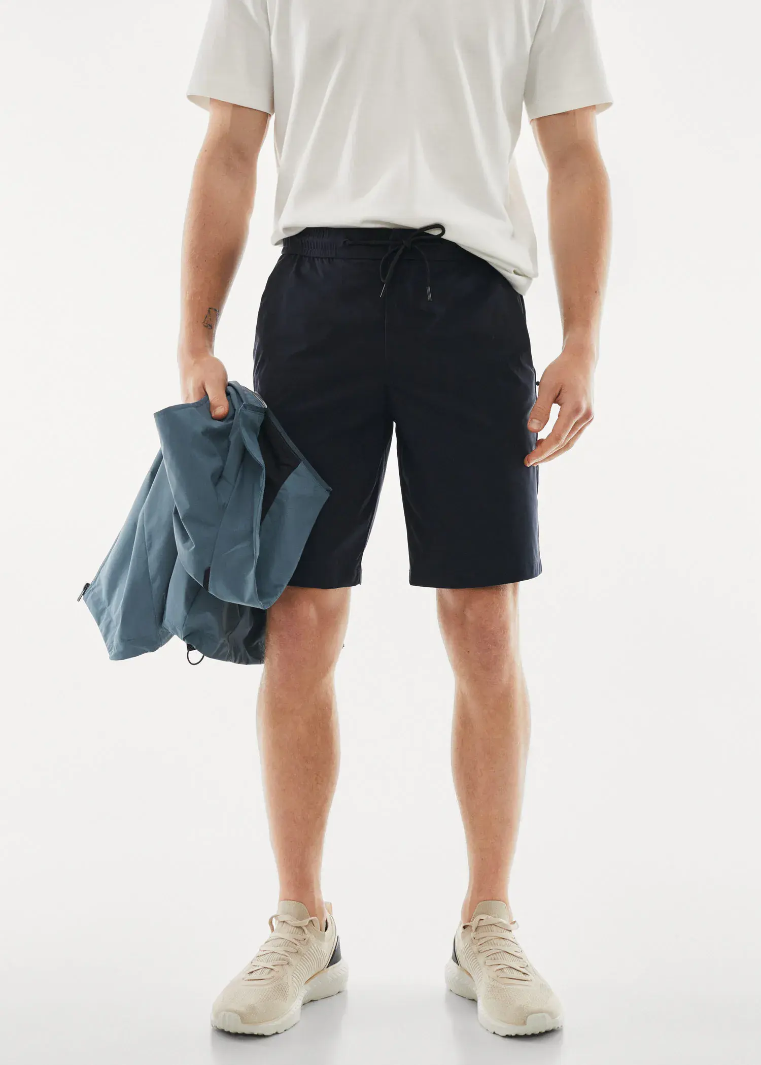 Mango Technical fabric bermuda shorts with drawstring. a man in black shorts and a white t-shirt. 