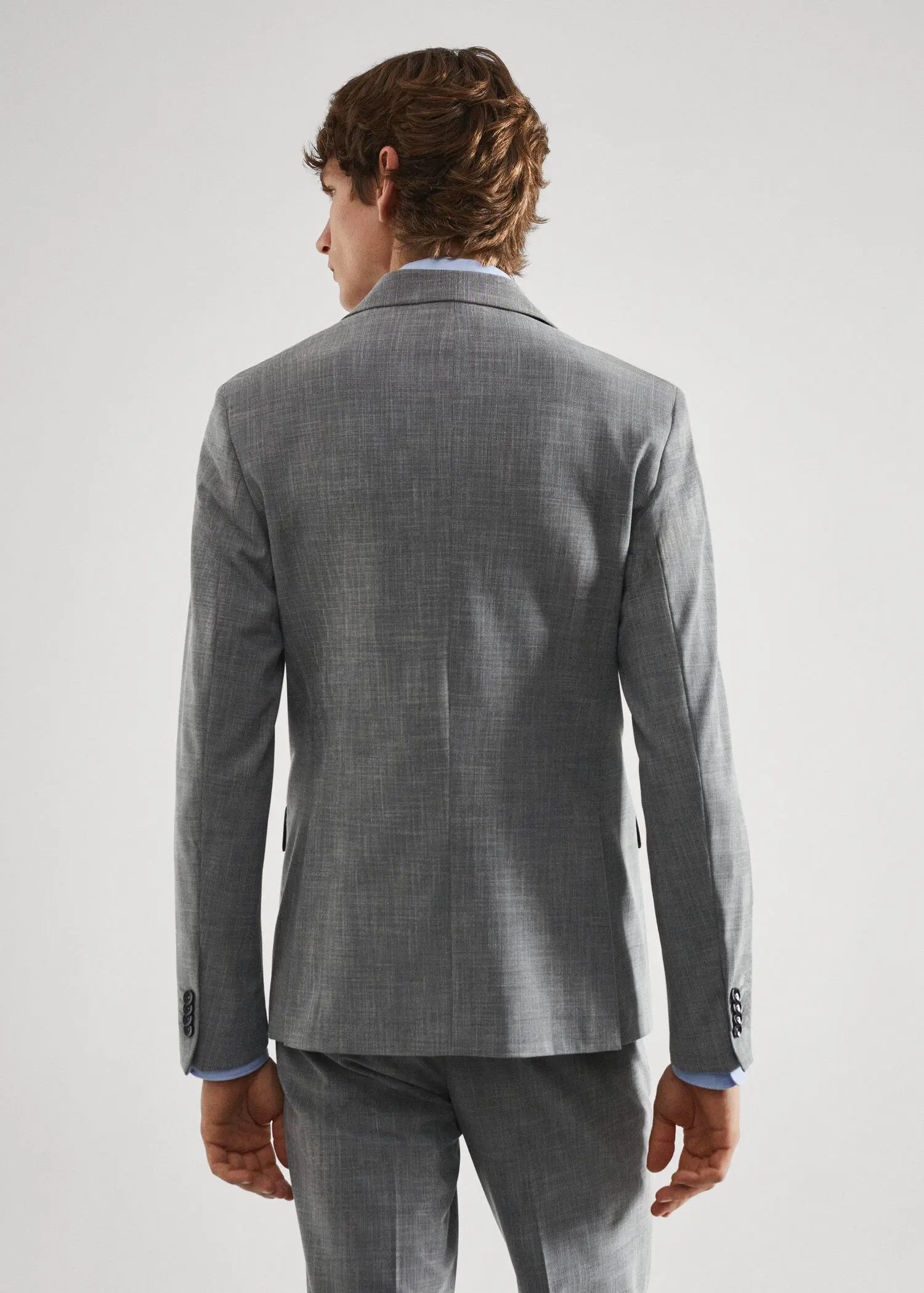 Mango Stretch fabric slim-fit printed suit jacket . a man wearing a suit standing in front of a white wall. 
