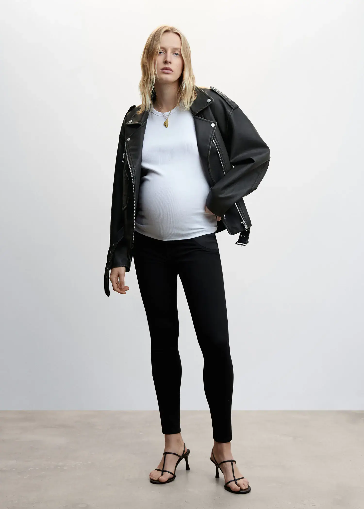 Mango Maternity skinny jeans. a pregnant woman wearing a black jacket and black pants. 