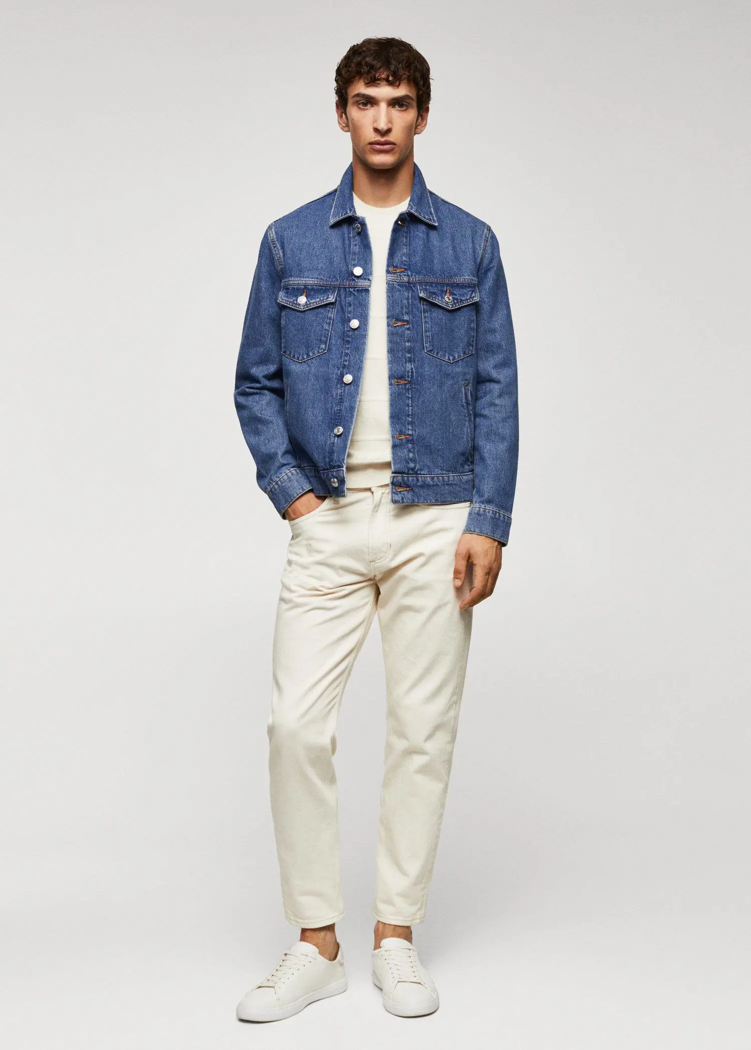 Mango Basic denim jacket. a man wearing a jean jacket and white pants. 