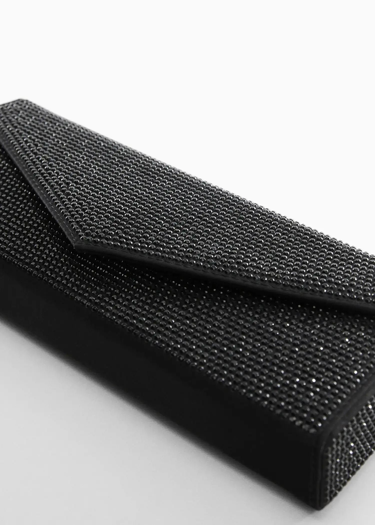 Mango Rigid crystal bag. a close-up of a black purse on a white surface. 