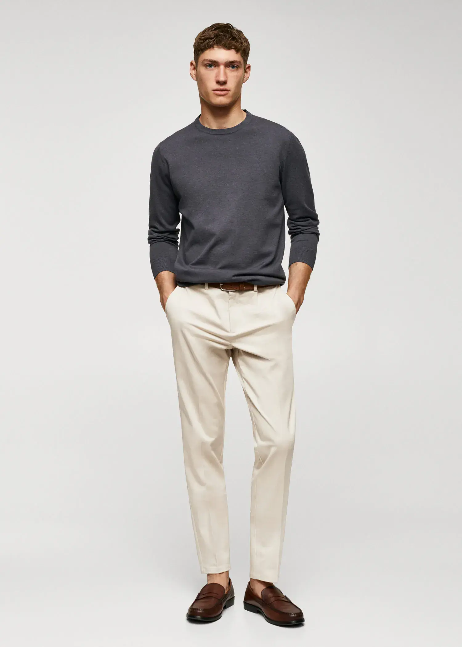 Mango Slim fit chino trousers. a man standing with his hands in his pockets. 