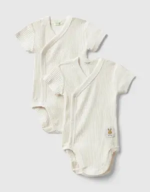 two short sleeve ribbed knit bodysuits