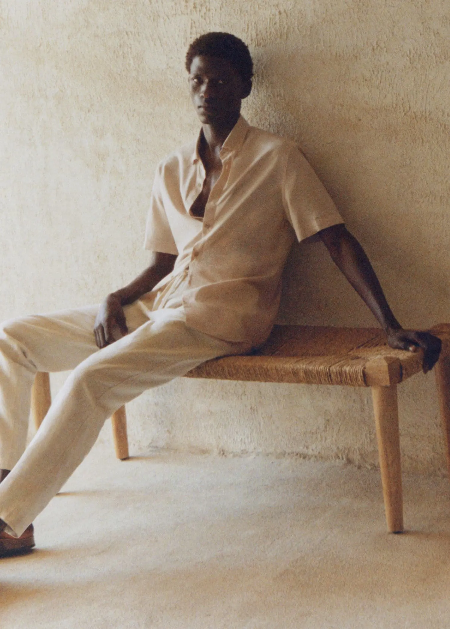 Mango Slim-fit trousers with drawstring . a man sitting on top of a wooden bench. 