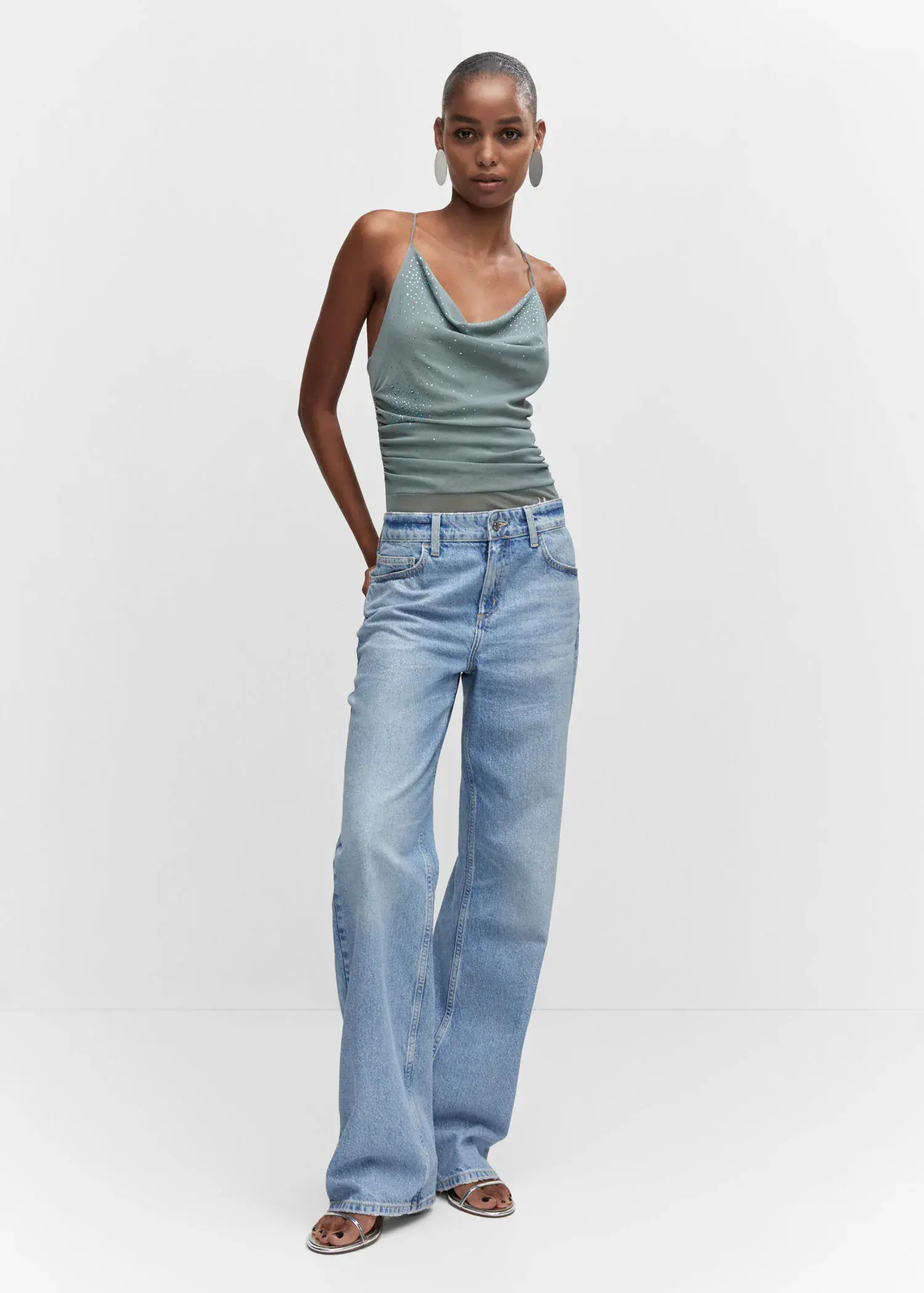 Mango Draped body with rhinestone detail. a woman wearing a tank top and jeans. 