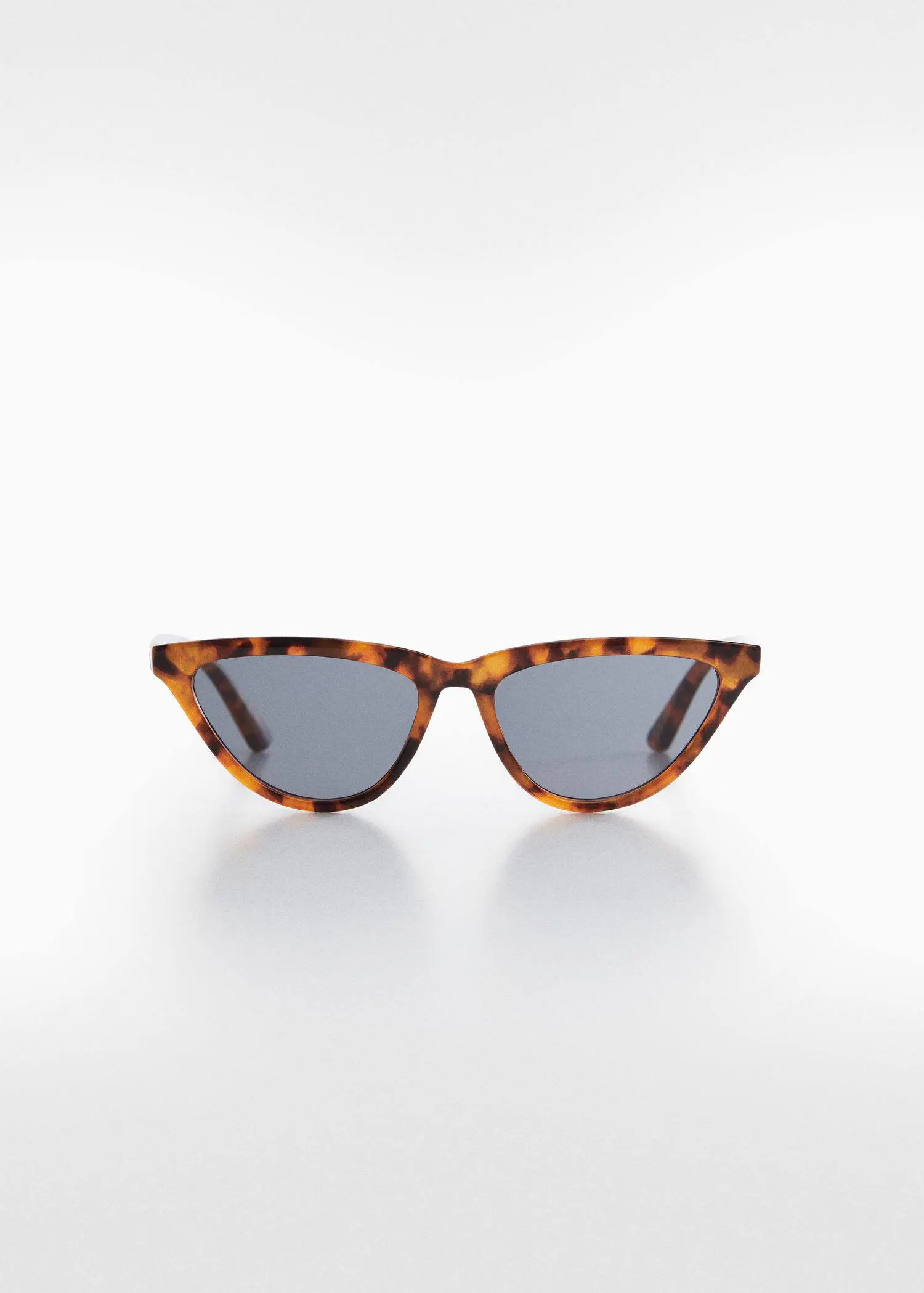 Mango Retro style sunglasses. a pair of cat eye sunglasses on top of a table. 