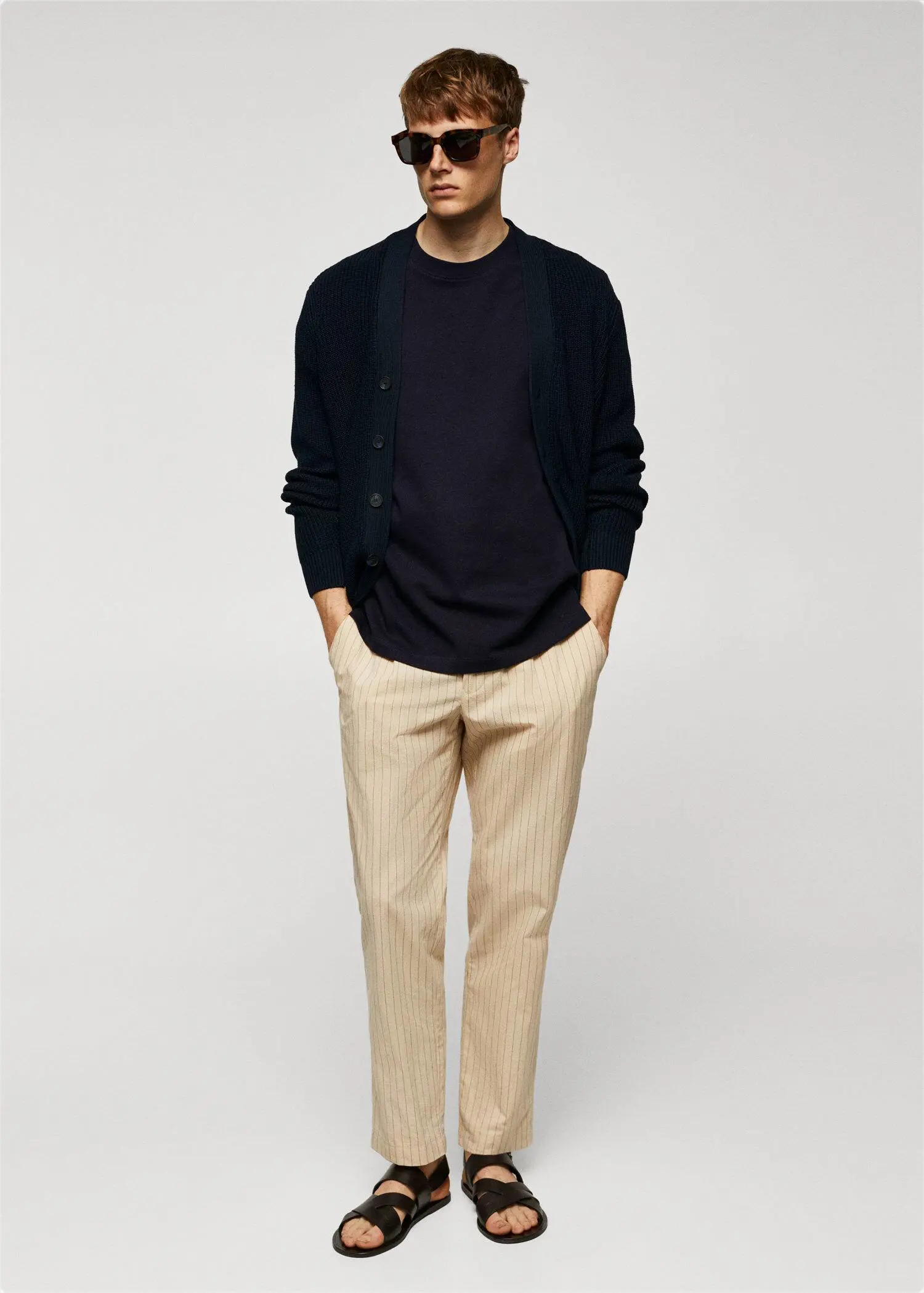 Mango Basic 100% cotton relaxed-fit t-shirt. a man wearing a black shirt and beige pants. 