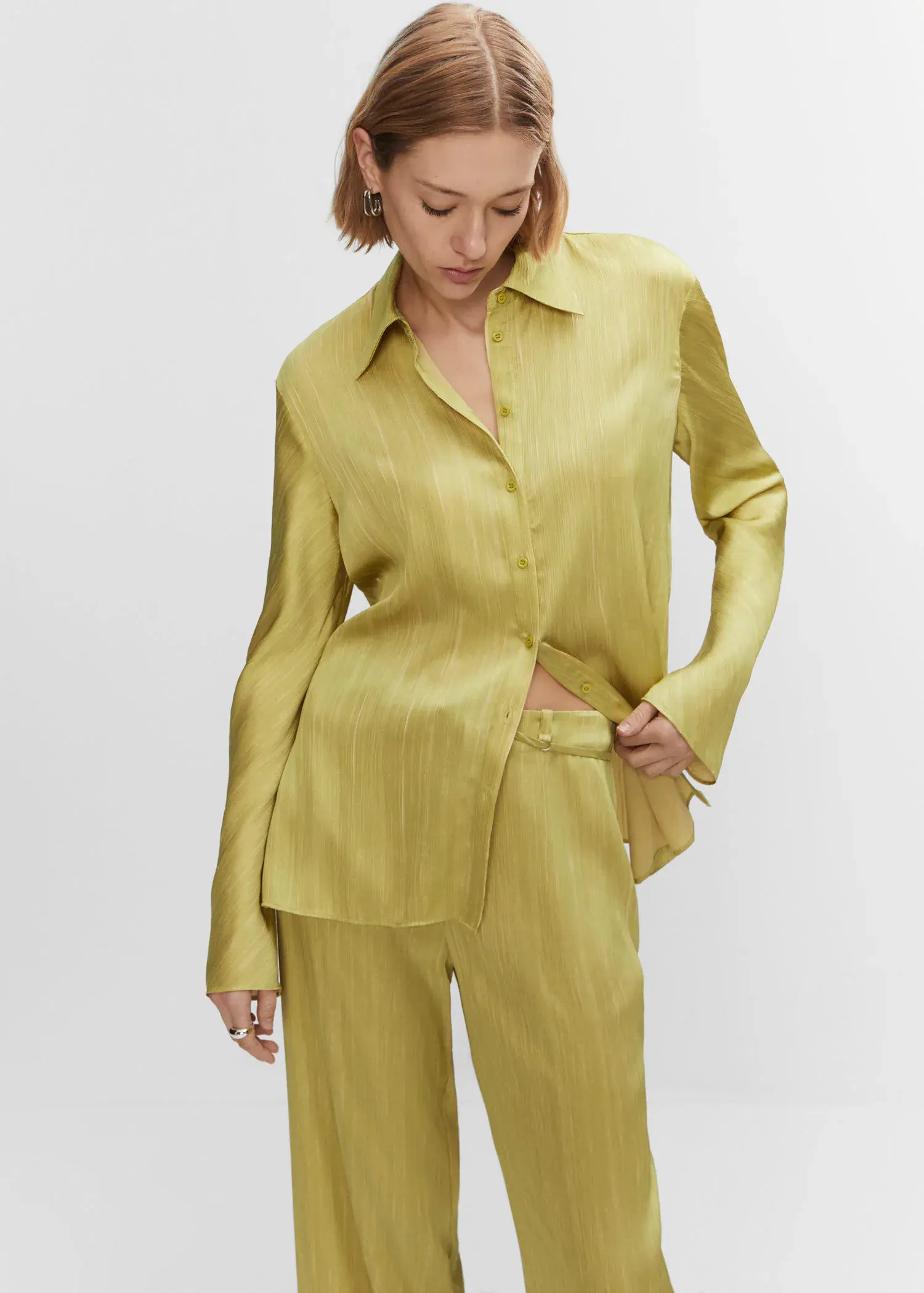 Mango Satin pleated shirt. a woman in a yellow shirt and pants. 