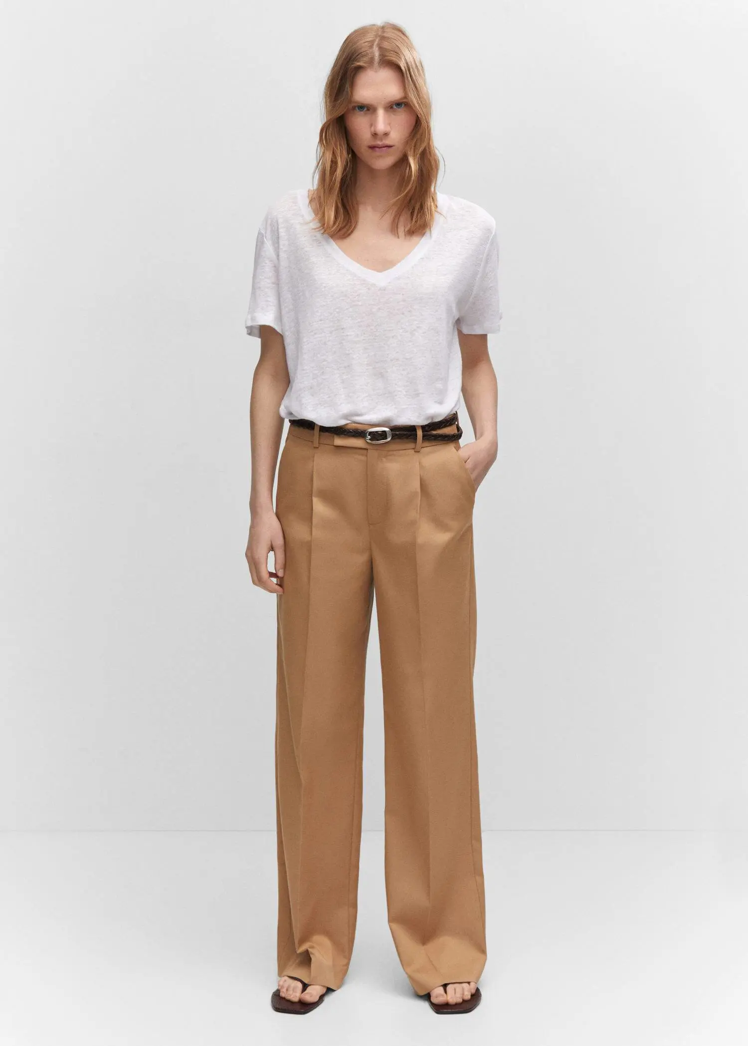 Mango V-neck linen t-shirt. a woman wearing a white shirt and brown pants. 