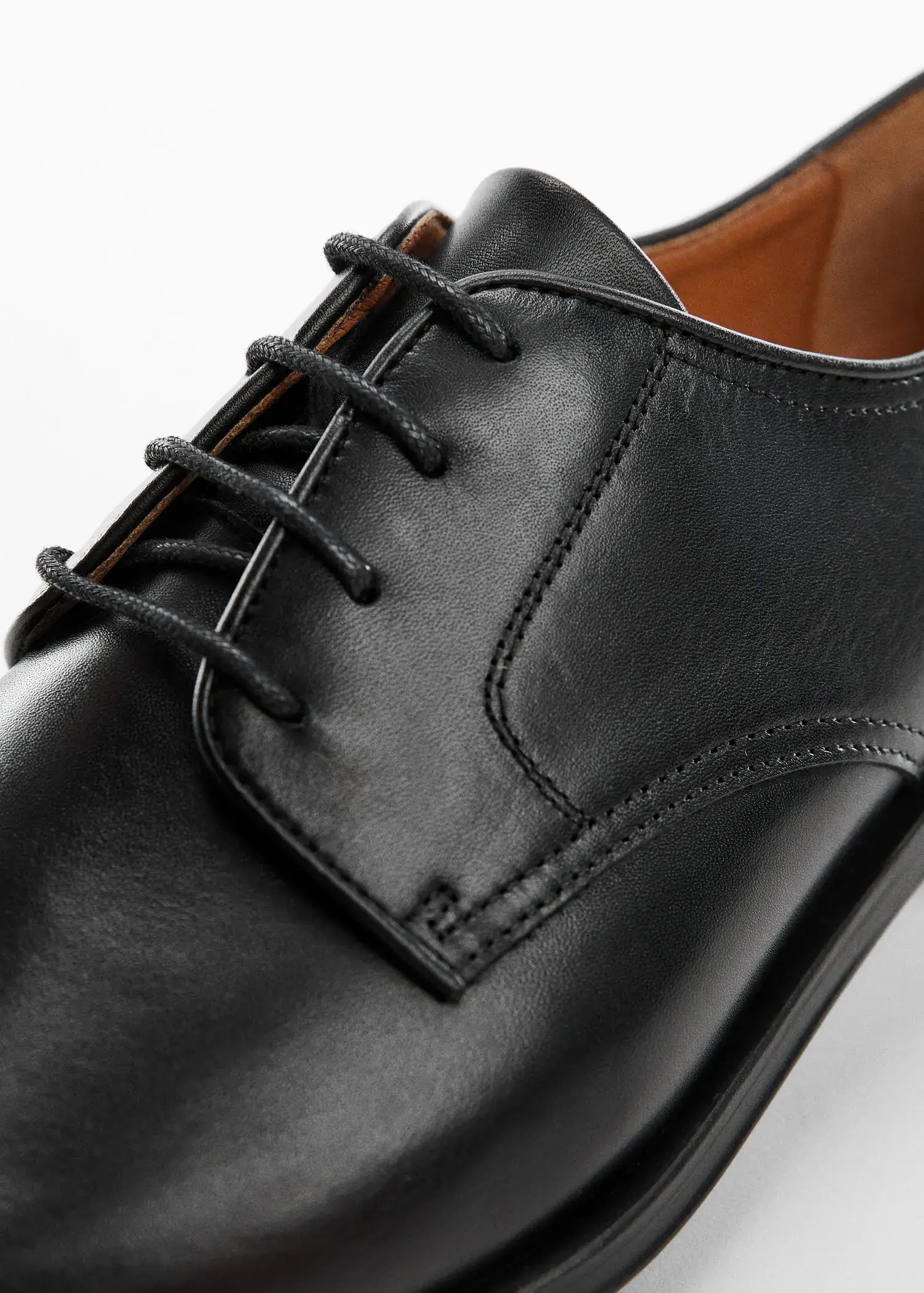 Mango Leather suit shoes. a close-up view of a pair of black shoes. 