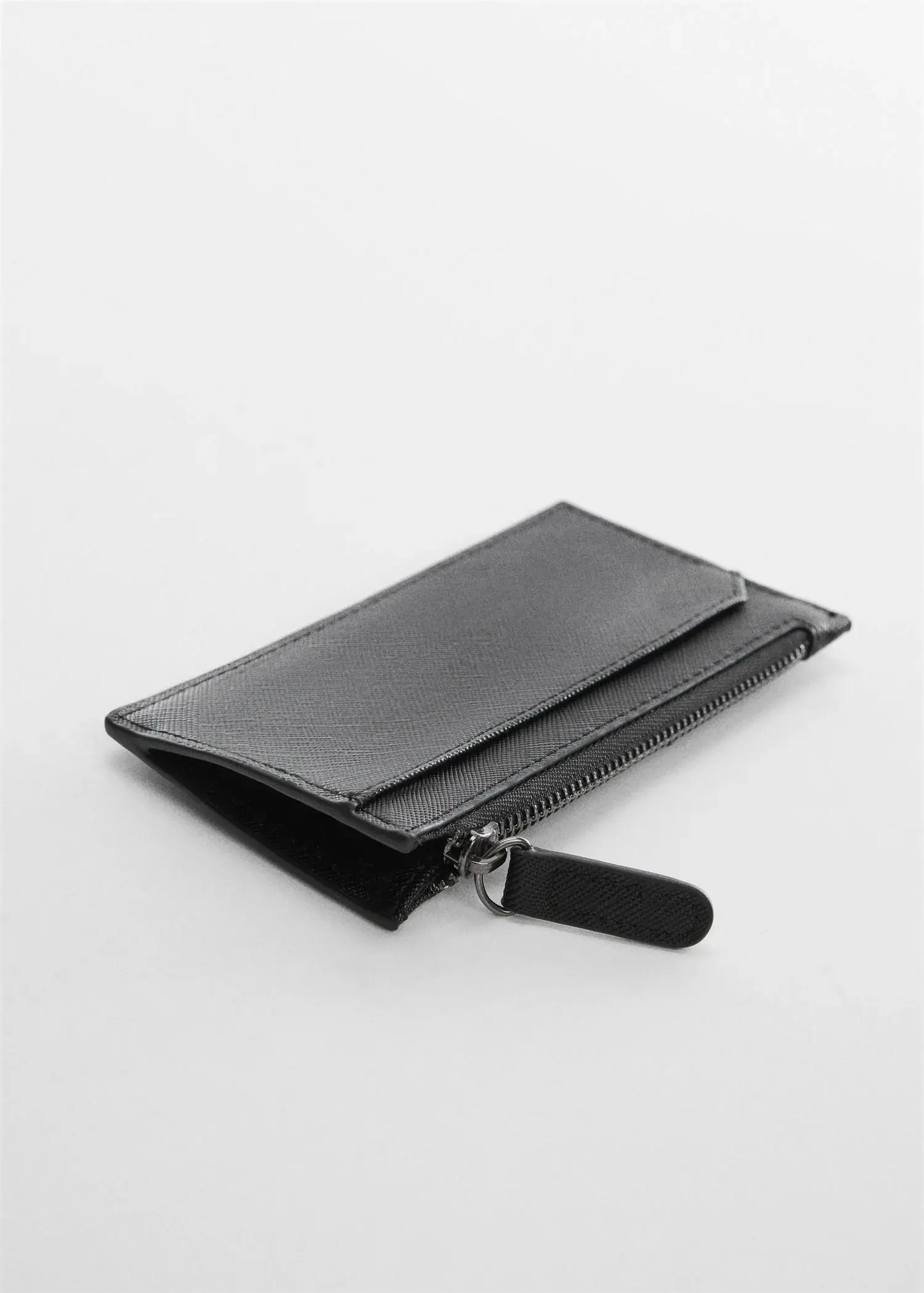 Mango Anti-contactless leather-effect card holder. a black wallet is sitting on a table. 