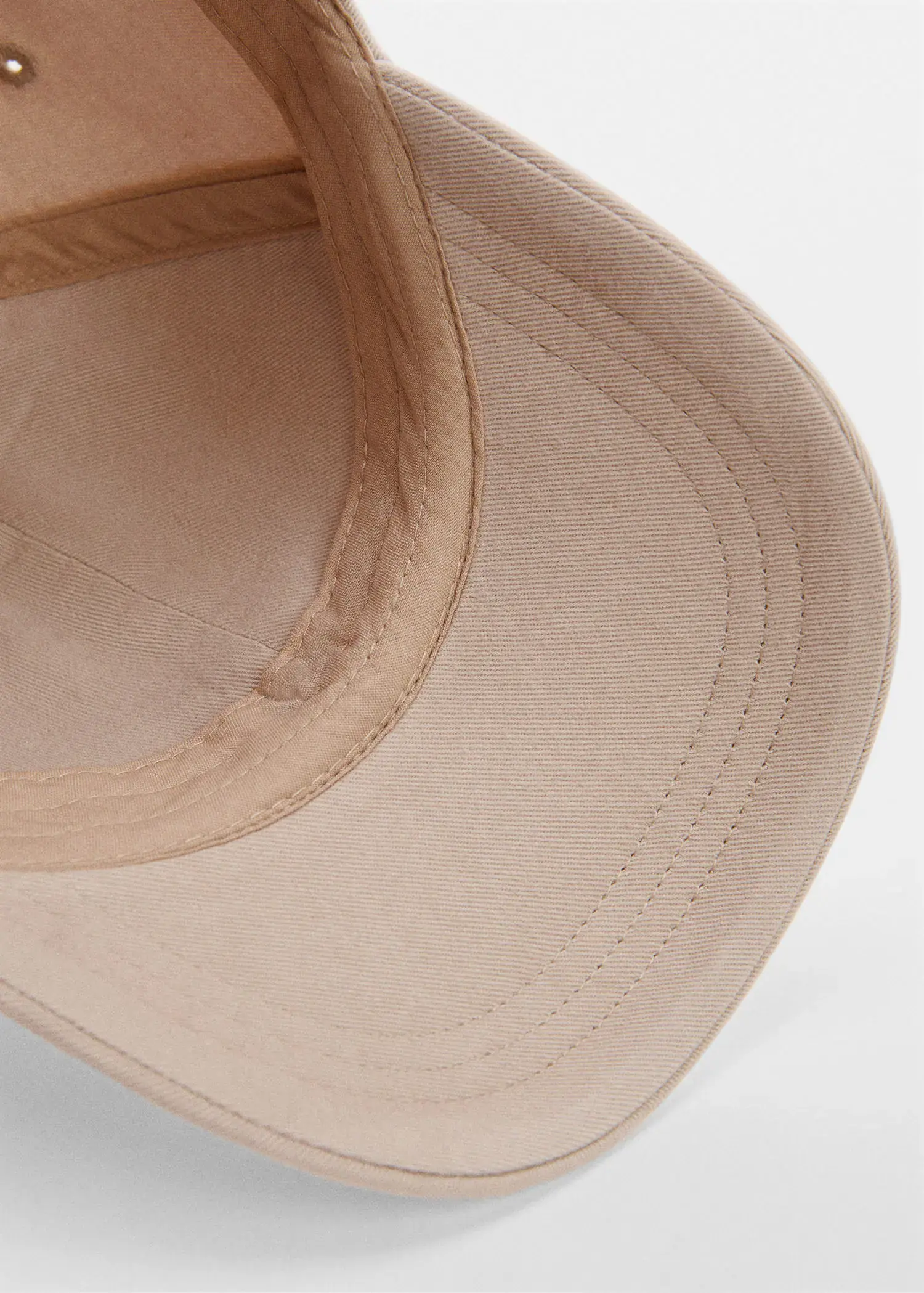 Mango Organic cotton cap. a close-up view of a tan baseball hat. 