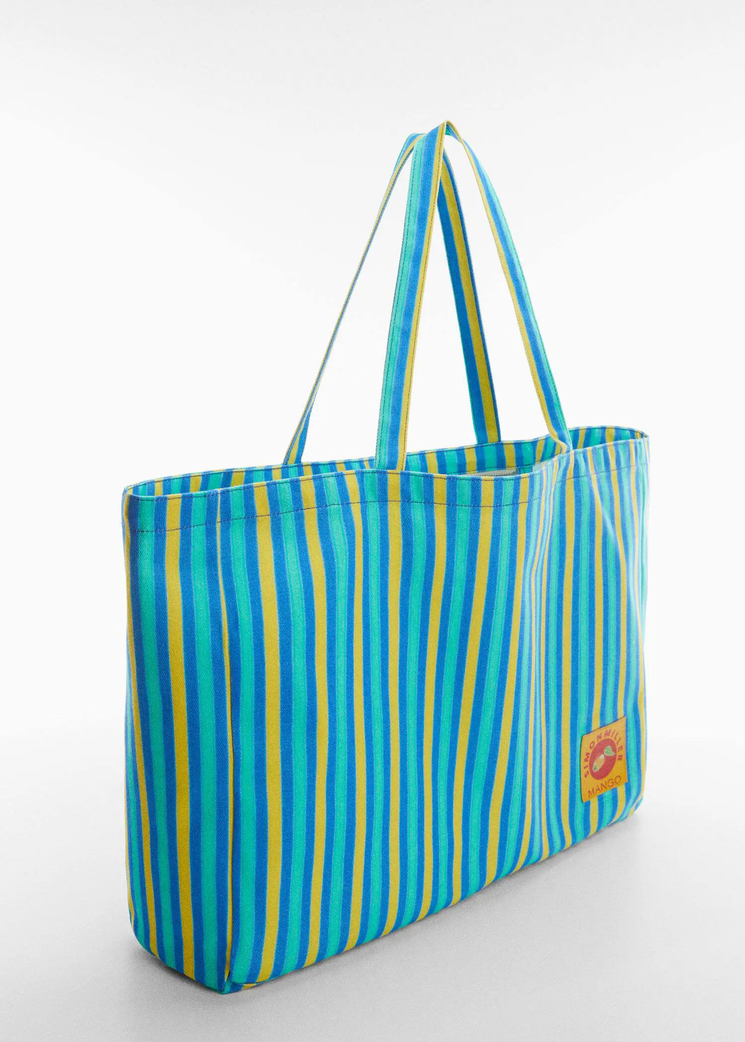 Mango Multi-coloured striped maxi bag. a close up of a bag on a white surface 