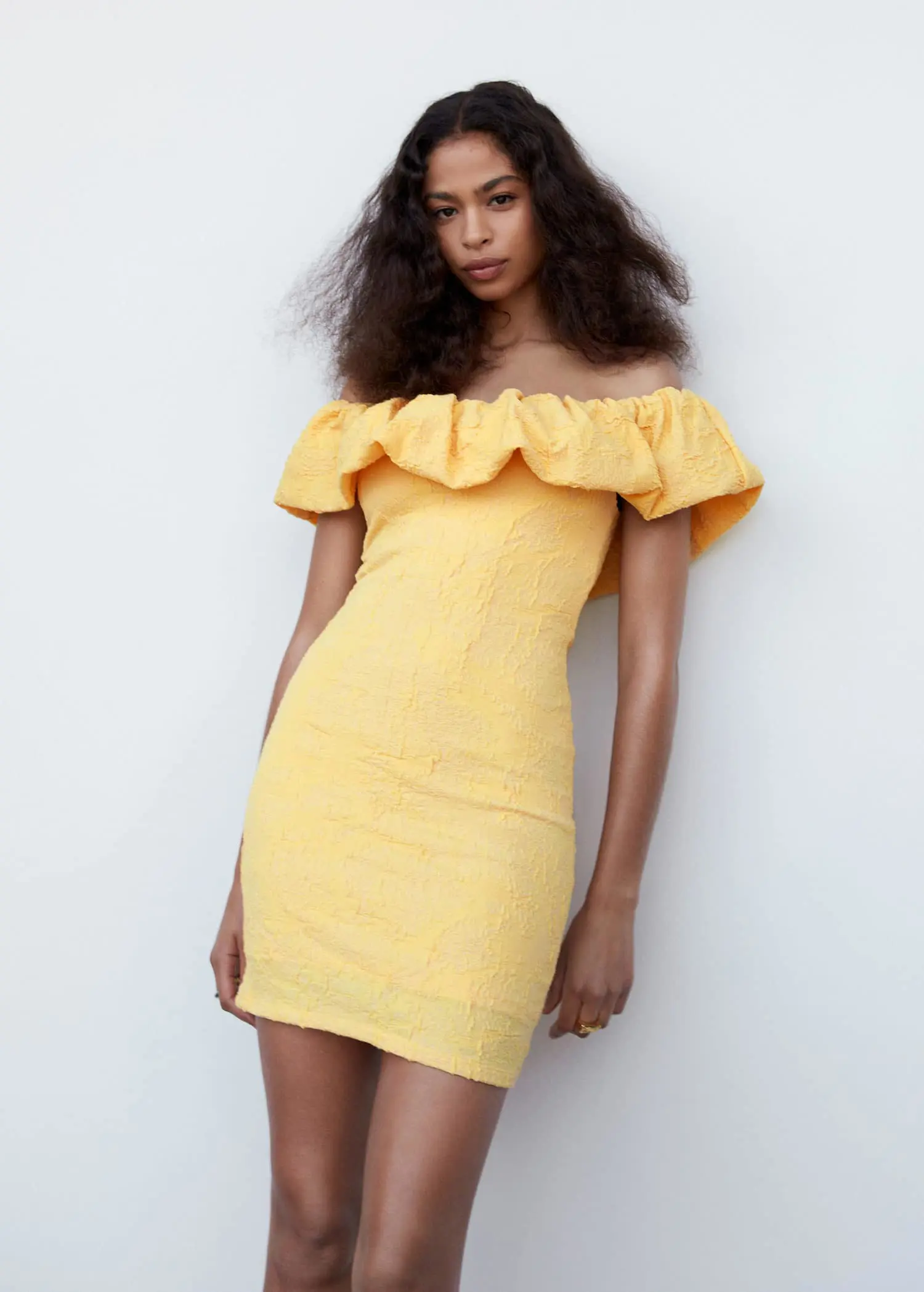 Mango Textured ruffled dress. a woman in a yellow dress posing for a picture. 