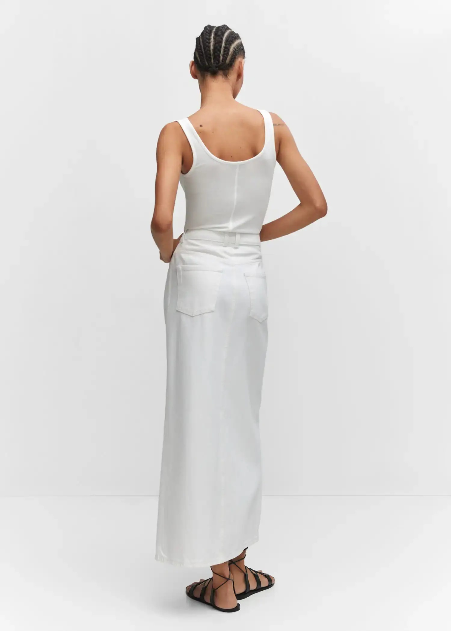 Mango Strapless halter neck top. a woman in a white dress standing in front of a wall. 