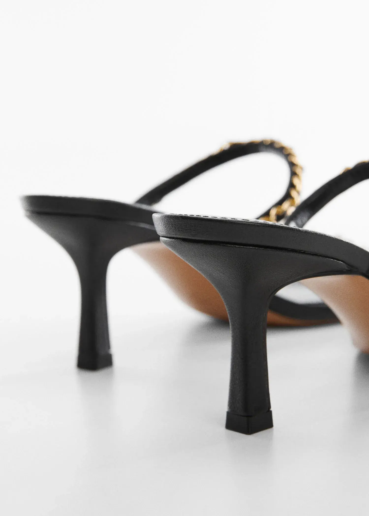 Mango High-heeled sandals with chain detail. a close up of a pair of shoes on a table 