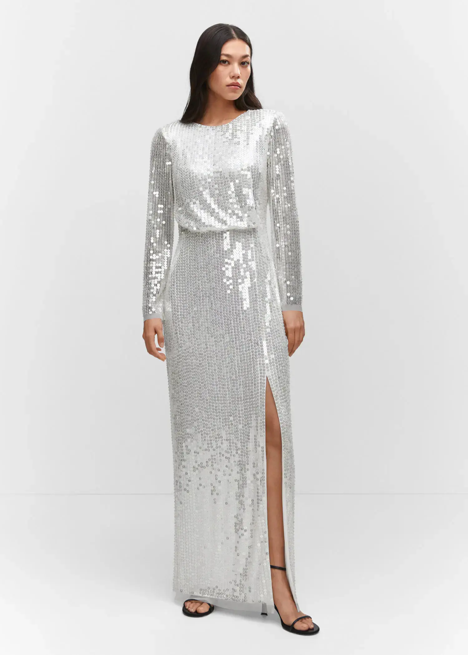Mango Side slit sequined gown. a woman wearing a long white sequined dress. 