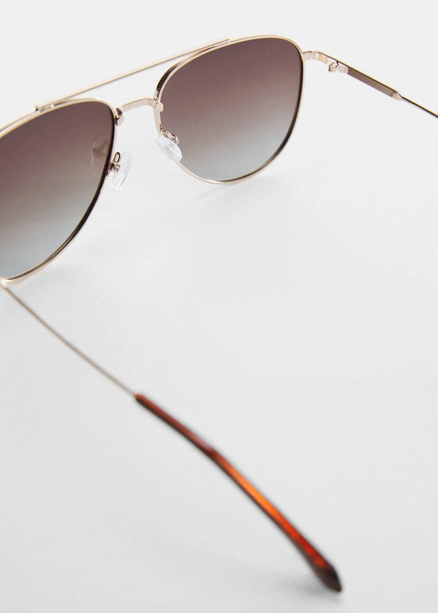 Mango Polarised sunglasses. a close up of a pair of sunglasses on a table 