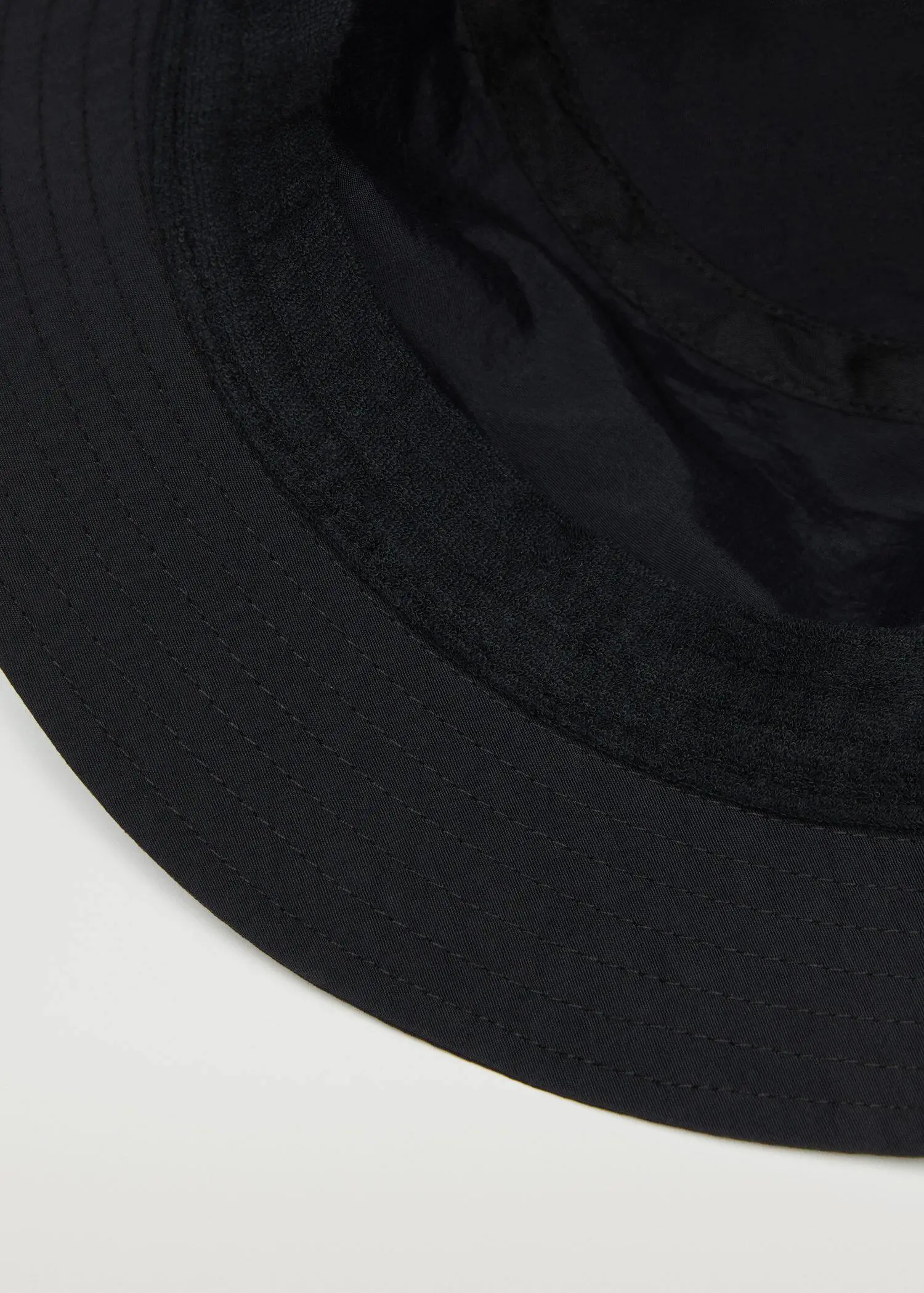 Mango Breathable hiking hat. a close-up view of a black hat. 
