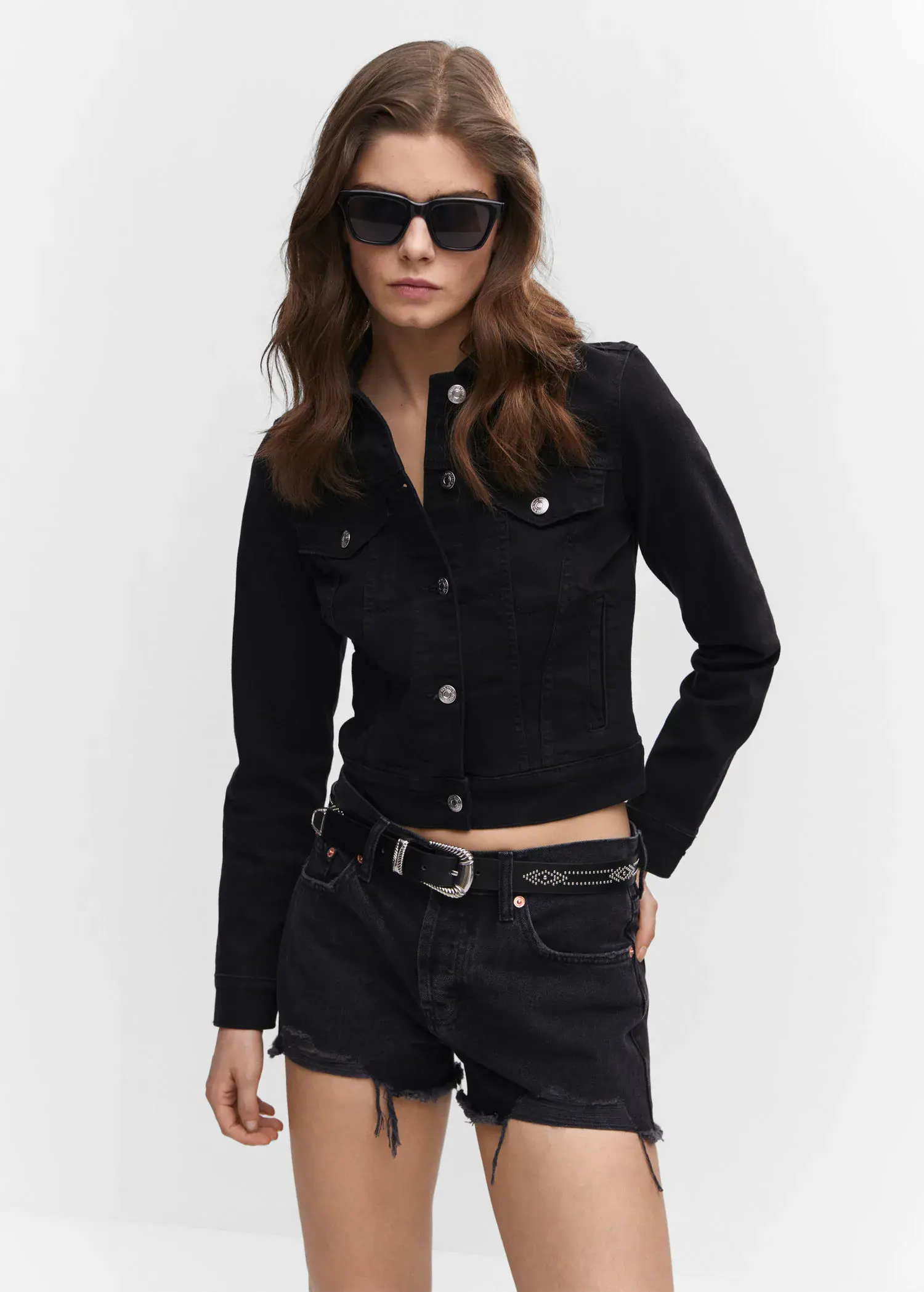 Mango Pocketed denim jacket. a woman wearing a black shirt and black shorts. 