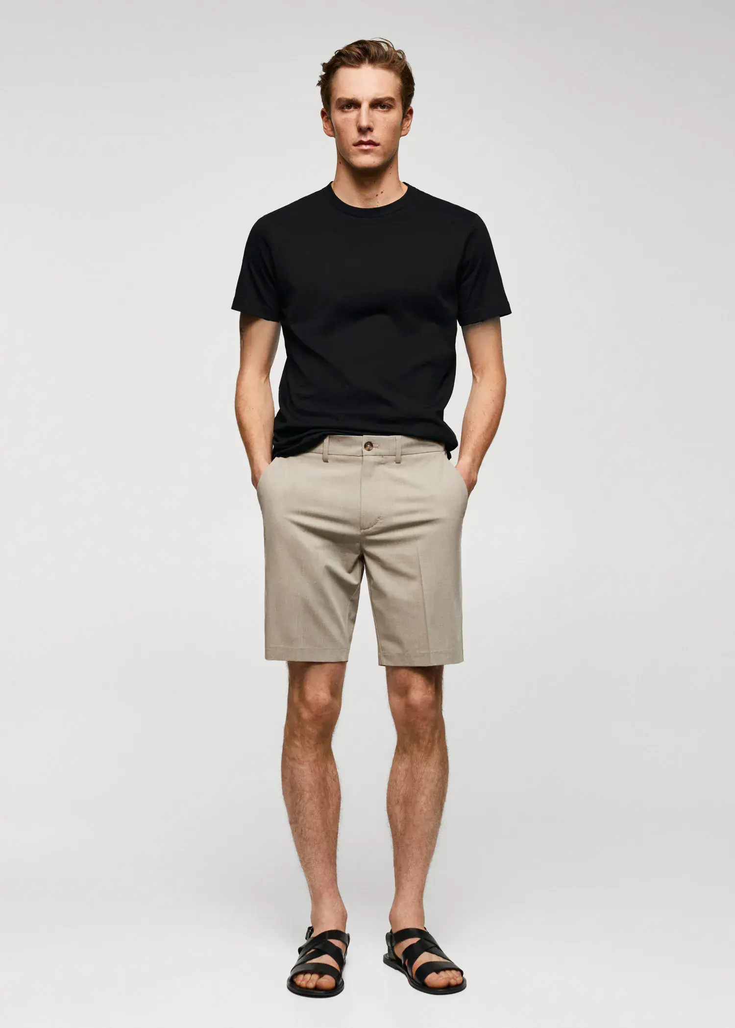 Mango Basic cotton stretch T-shirt. a man in black shirt and beige shorts. 