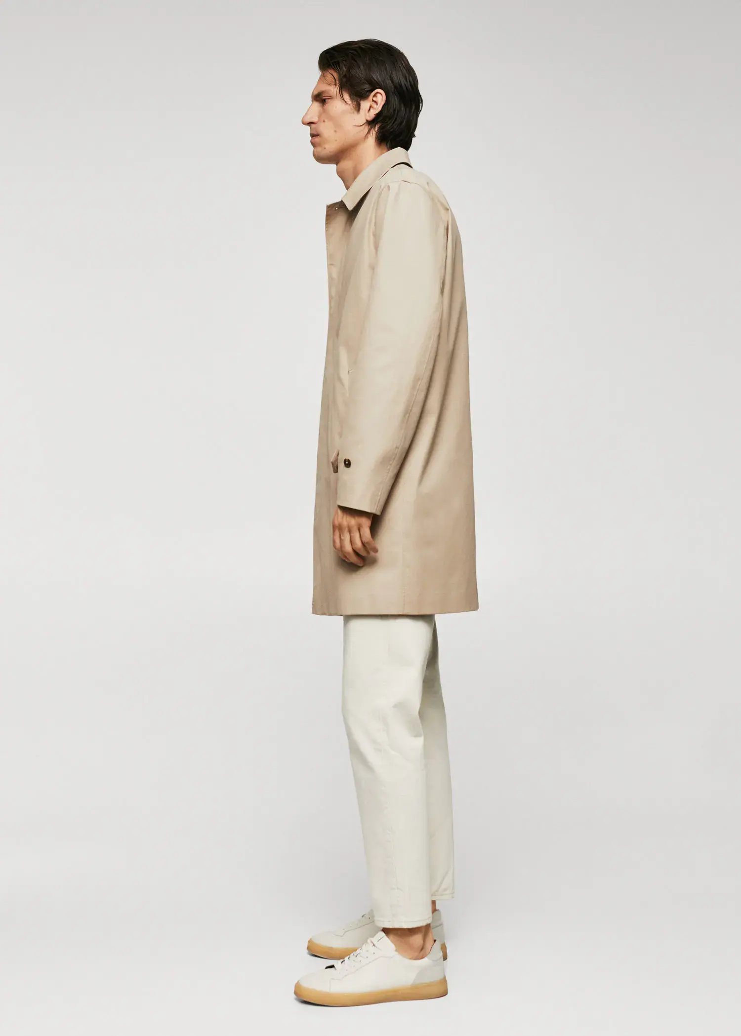 Mango Water-repellent cotton trench coat. a man wearing a tan coat and white pants. 