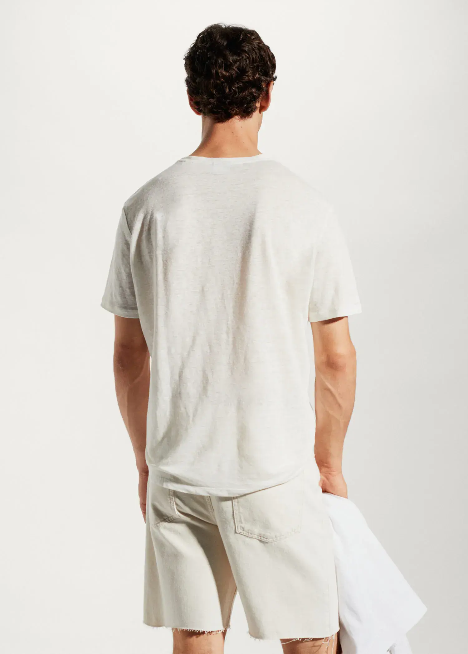 Mango 100% linen slim-fit t-shirt. a man wearing a white t-shirt and white shorts. 