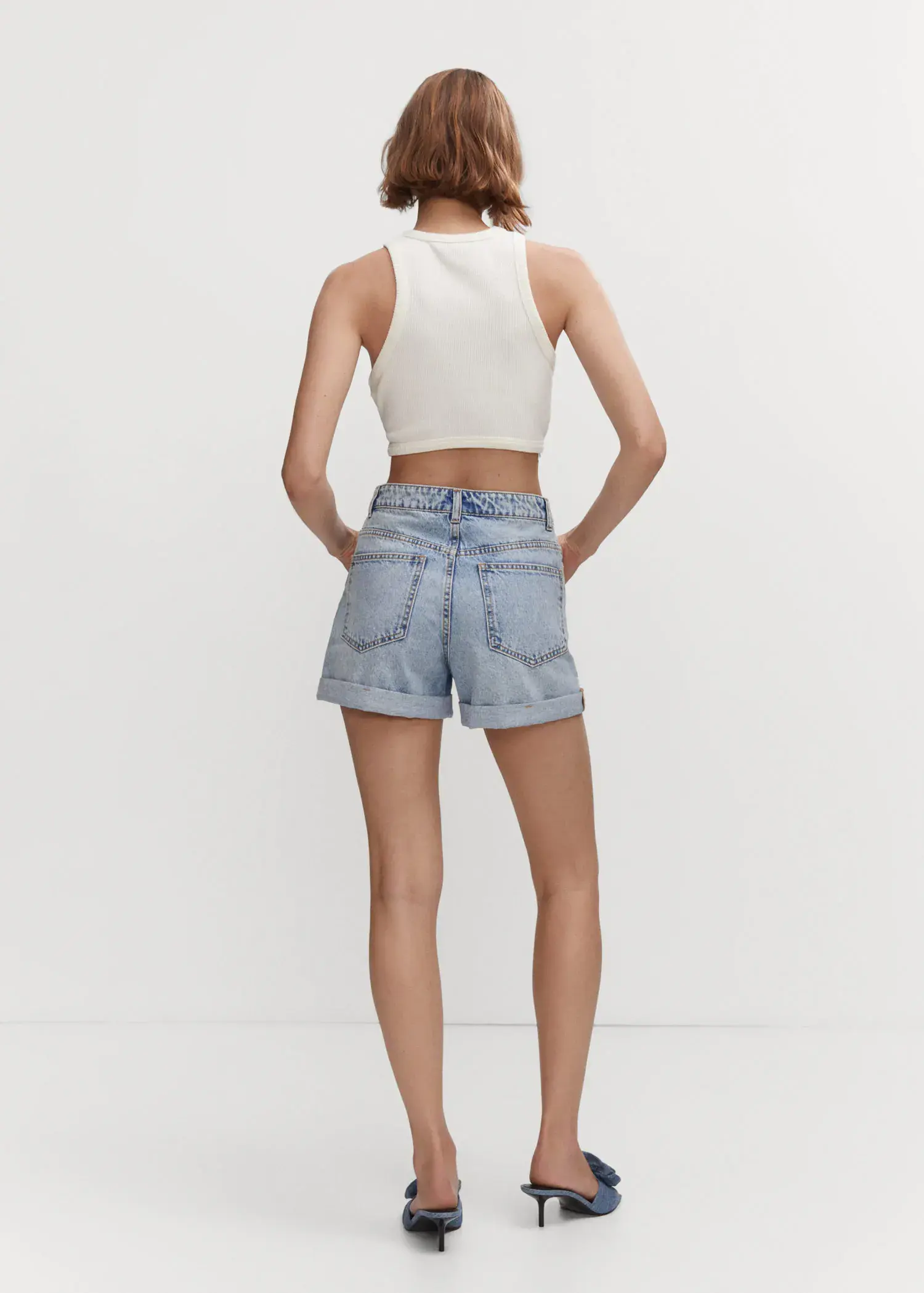 Mango Mom-fit denim shorts. a woman in a white crop top and jean shorts. 