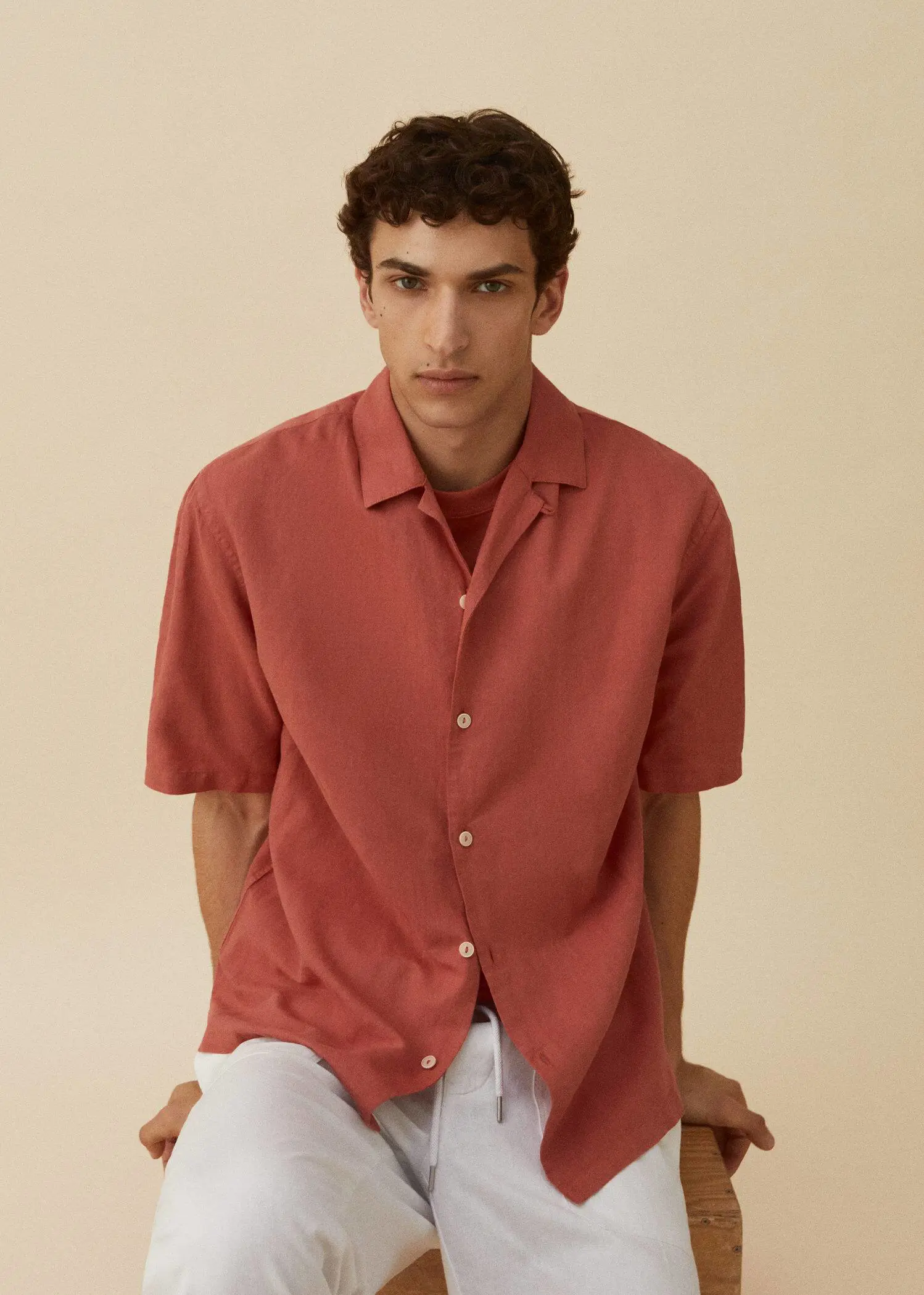 Mango Cotton-linen bowling-collar shirt. a man in a red shirt sitting on the ground. 