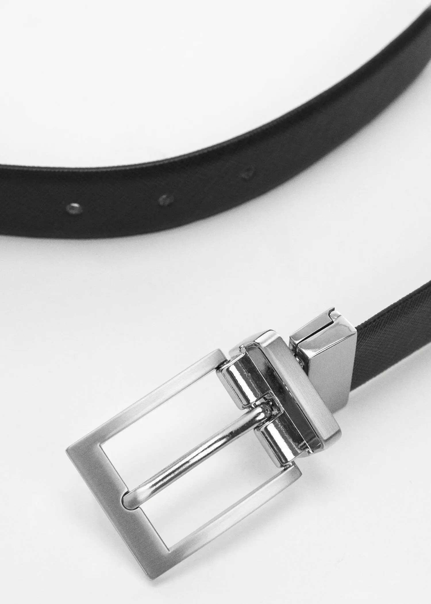 Mango Saffiano leather tailored belt. a close-up of a black belt and a silver buckle. 