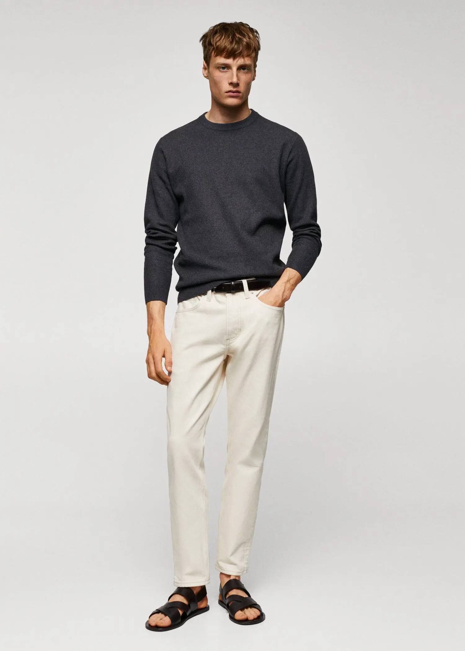 Mango Structured cotton sweater. a man in a black sweater and white pants. 