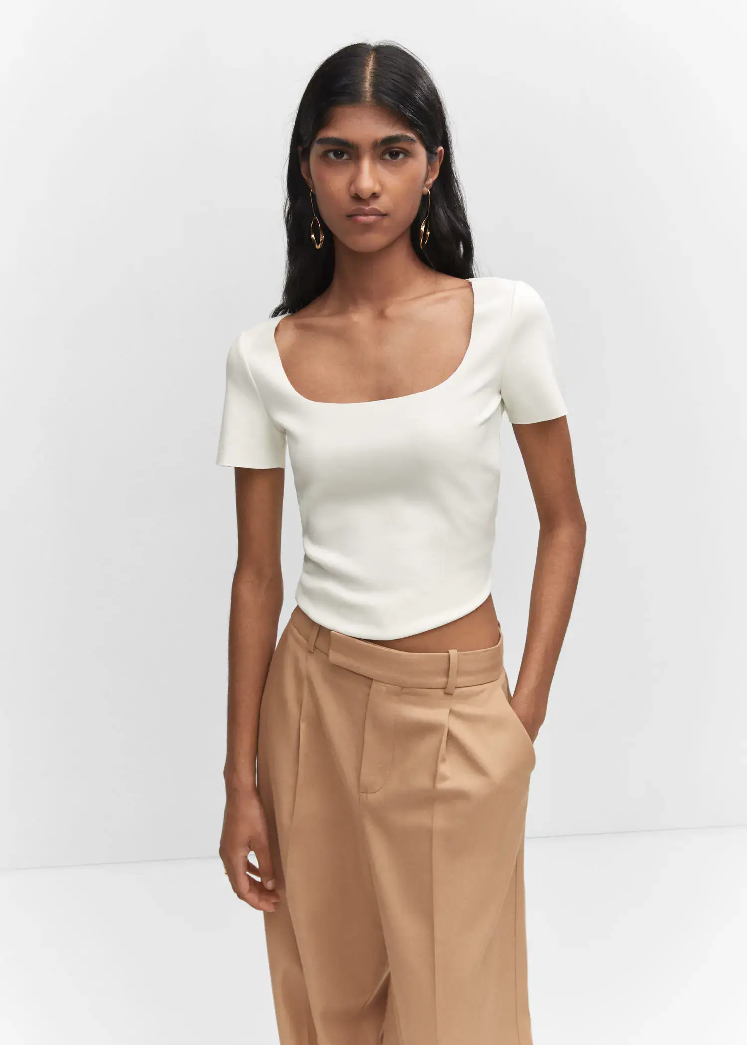 Mango Square neck t-shirt. a woman wearing a white top and brown skirt. 