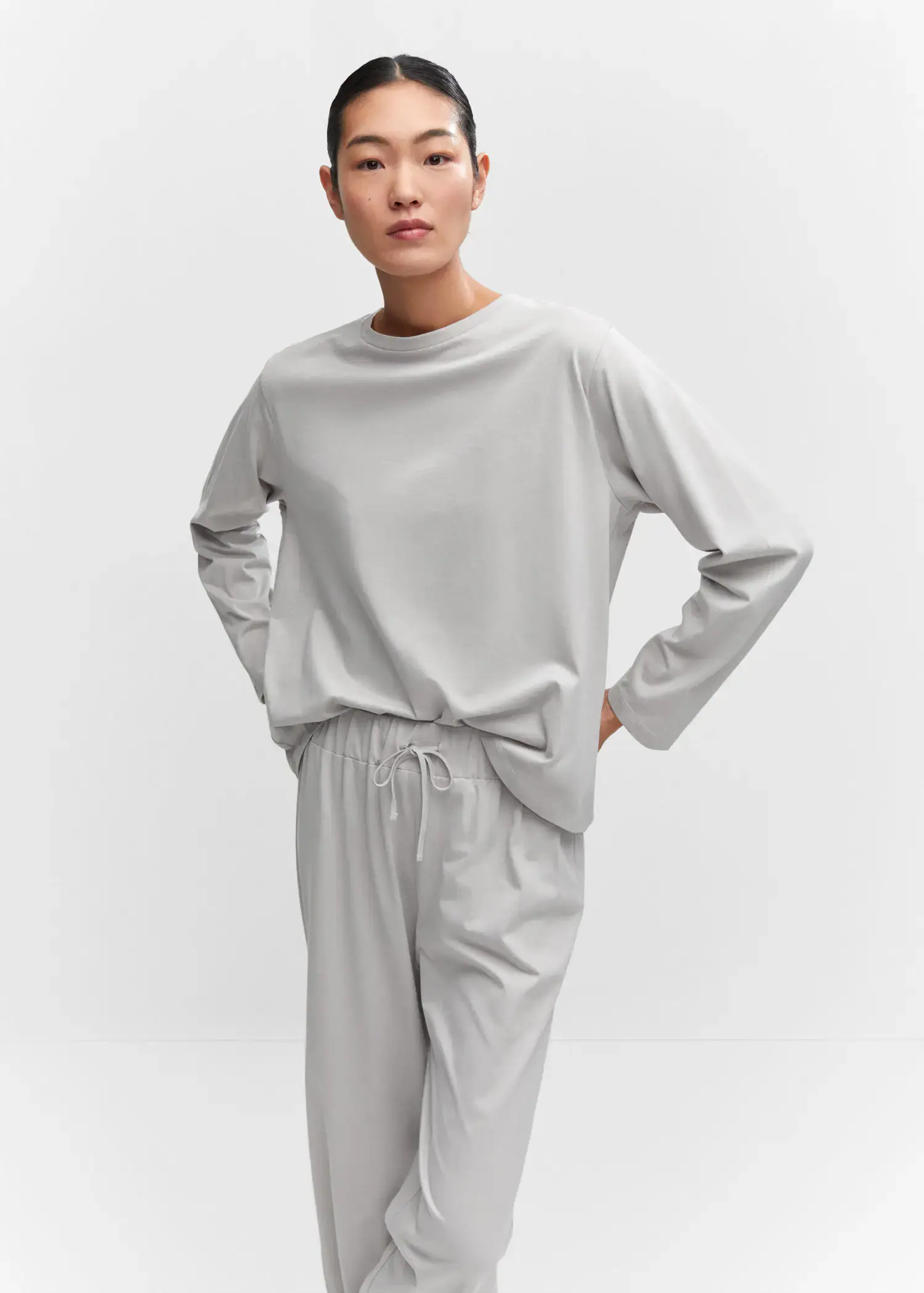 Mango Cotton long pyjamas. a person standing with their hands on their hips. 