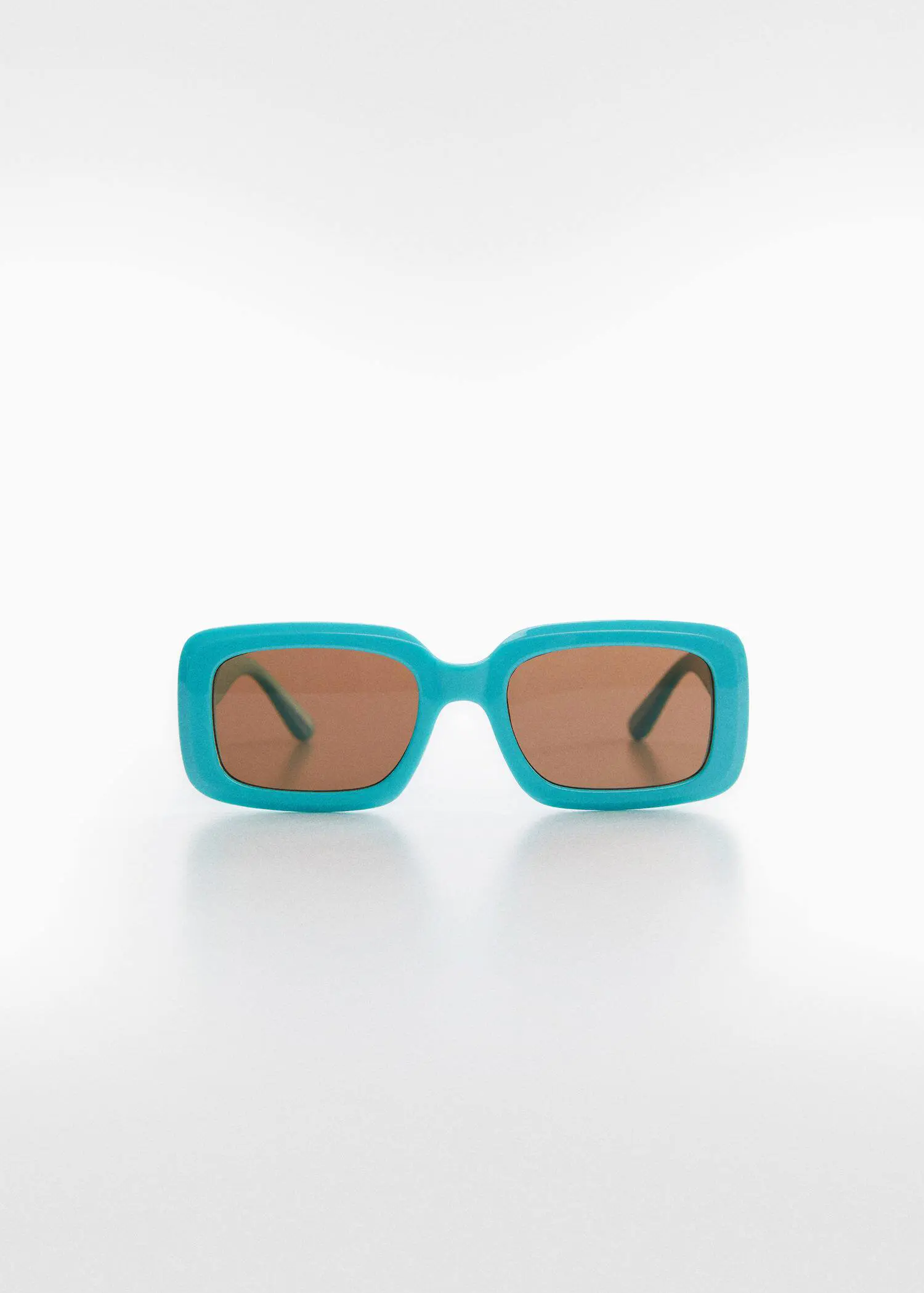Mango Rectangular sunglasses. a pair of sunglasses sitting on top of a white table. 