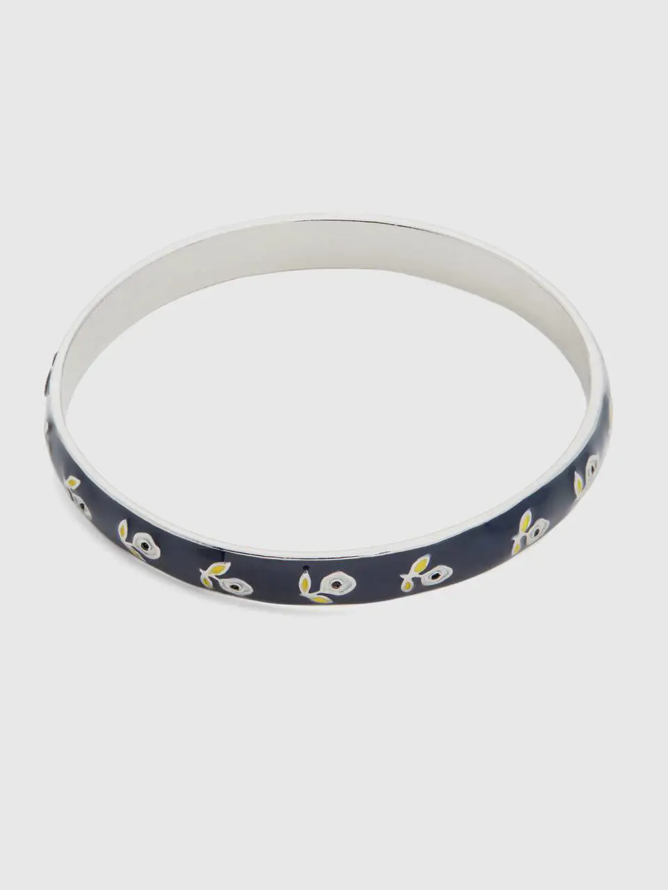 Benetton dark blue bangle bracelet with white flowers. 1