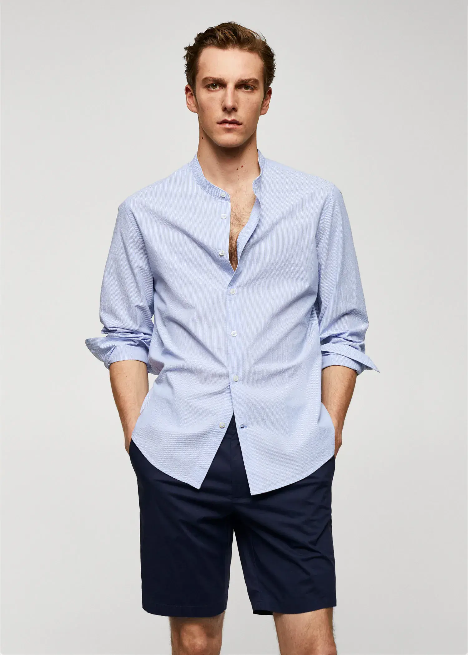 Mango Cotton seersucker shirt with multiple stripes. a man wearing a light blue dress shirt. 