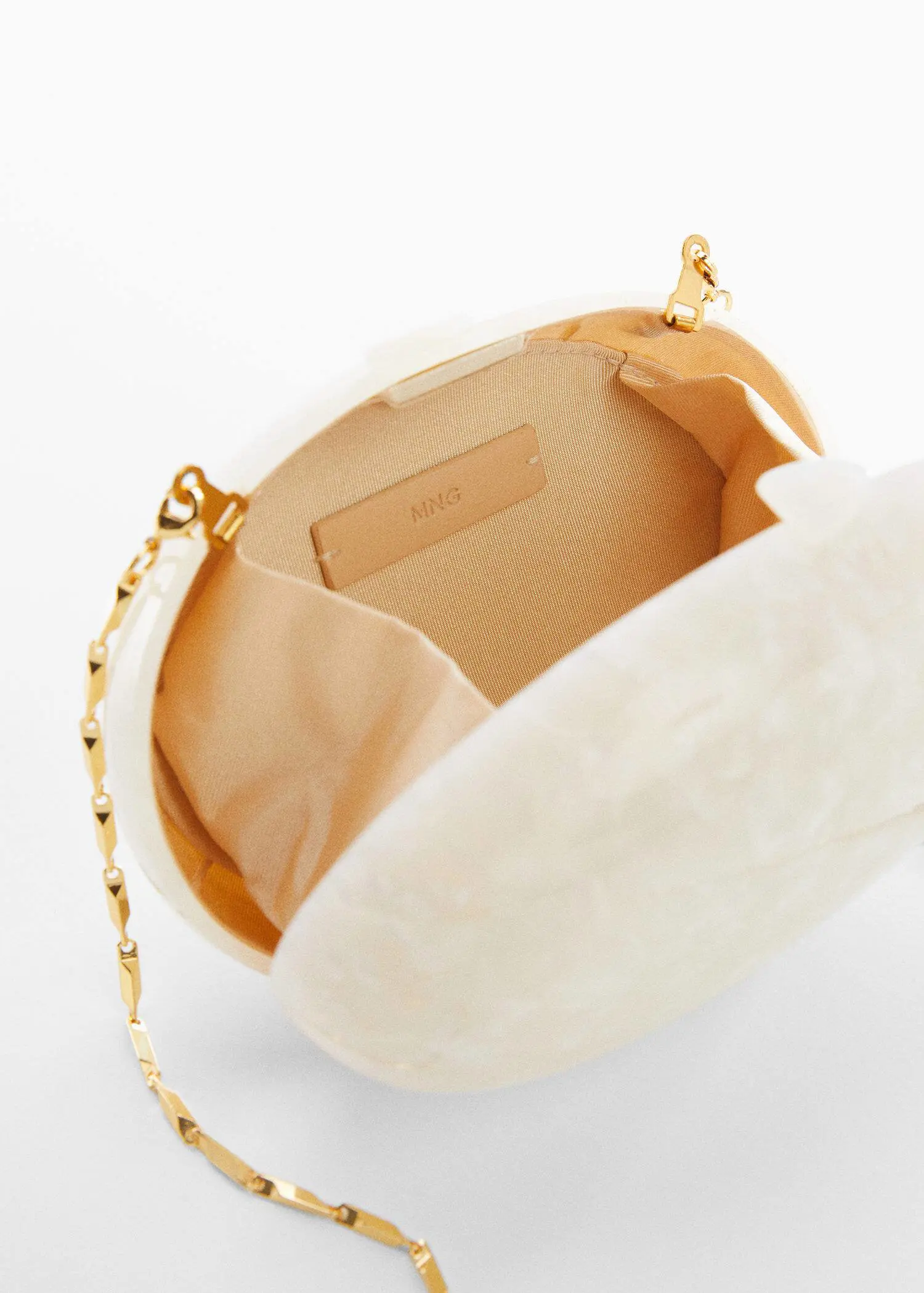 Mango Box clutch with chain. a close-up of the inside of a white purse. 