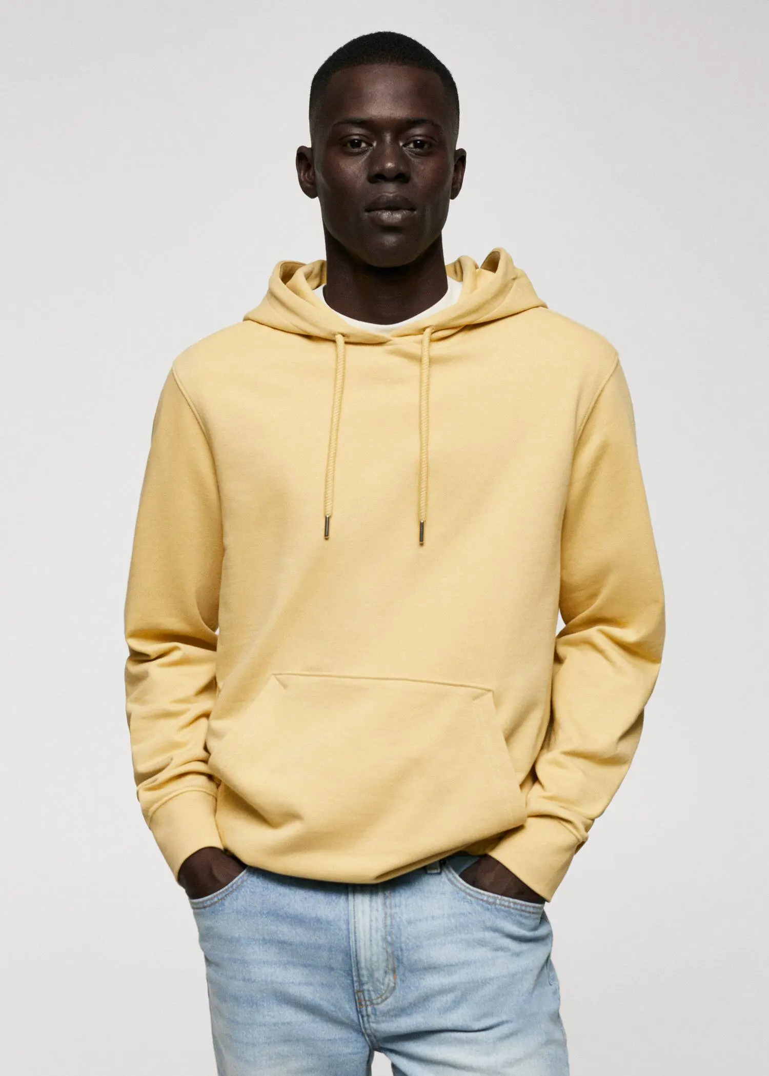 Mango Hoodie cotton sweatshirt. a man wearing a yellow hoodie and jeans. 