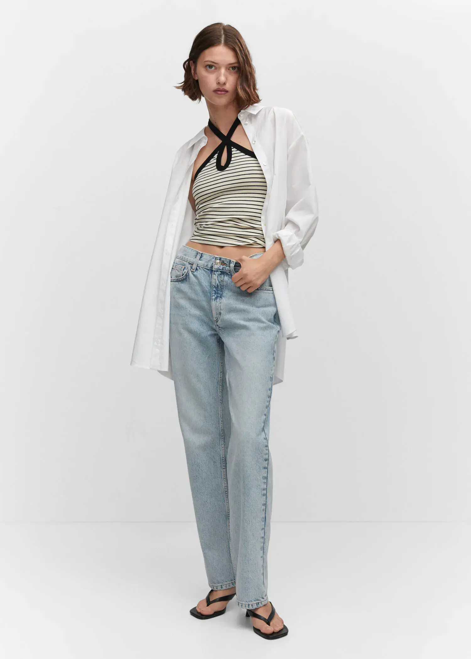 Mango Mid-rise straight jeans. a woman wearing a striped top and jeans. 