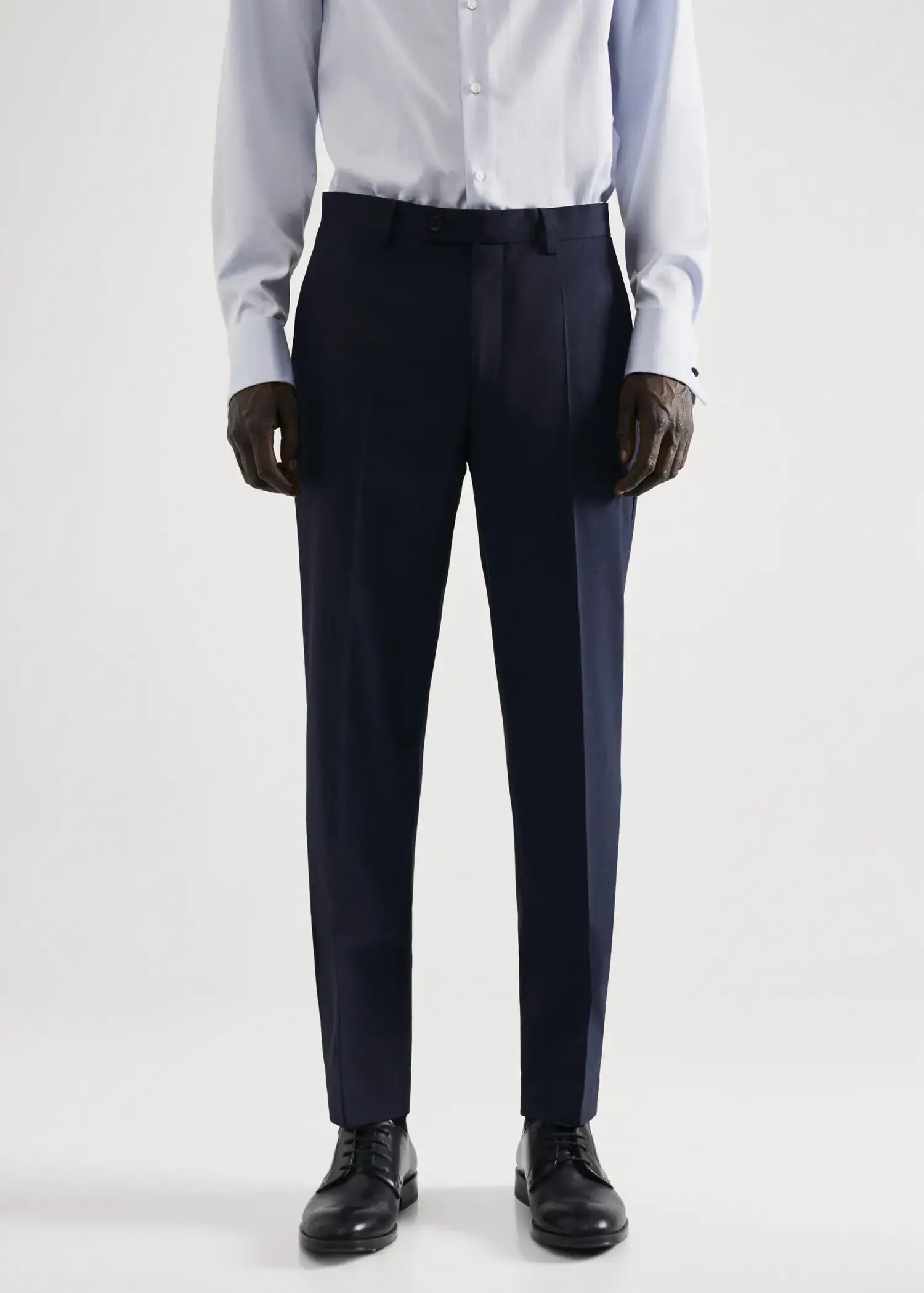 Mango Stretch fabric slim-fit suit pants. a man in a white dress shirt and black suit pants. 