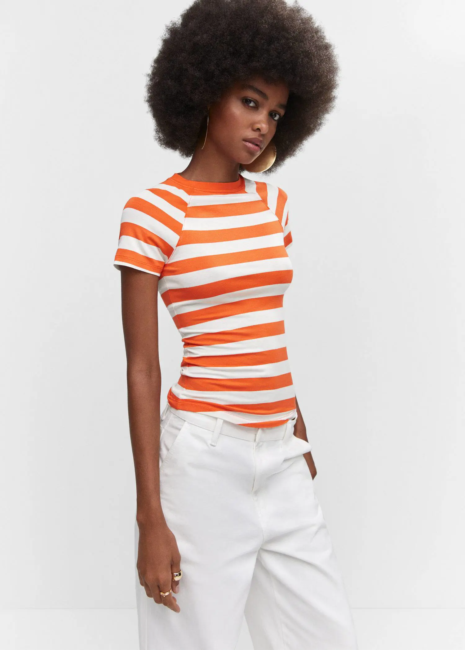 Mango Striped print T-shirt. a woman wearing a white and orange striped shirt. 