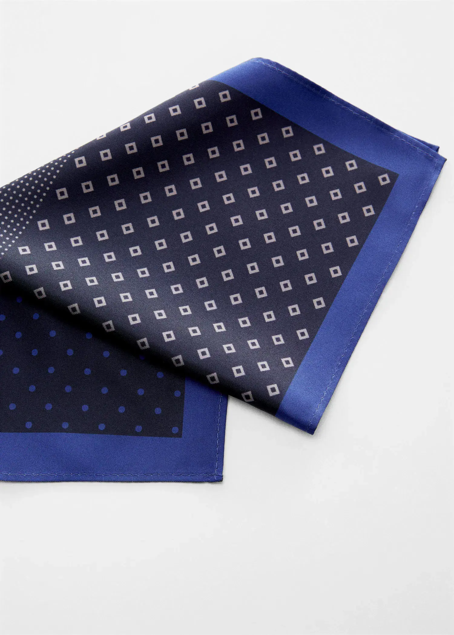 Mango Printed pocket square. a close-up of a blue and white patterned scarf. 