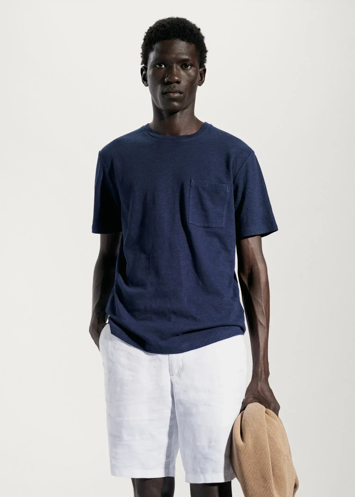 Mango Cotton-linen pocket t-shirt. a man wearing a blue shirt and white pants. 