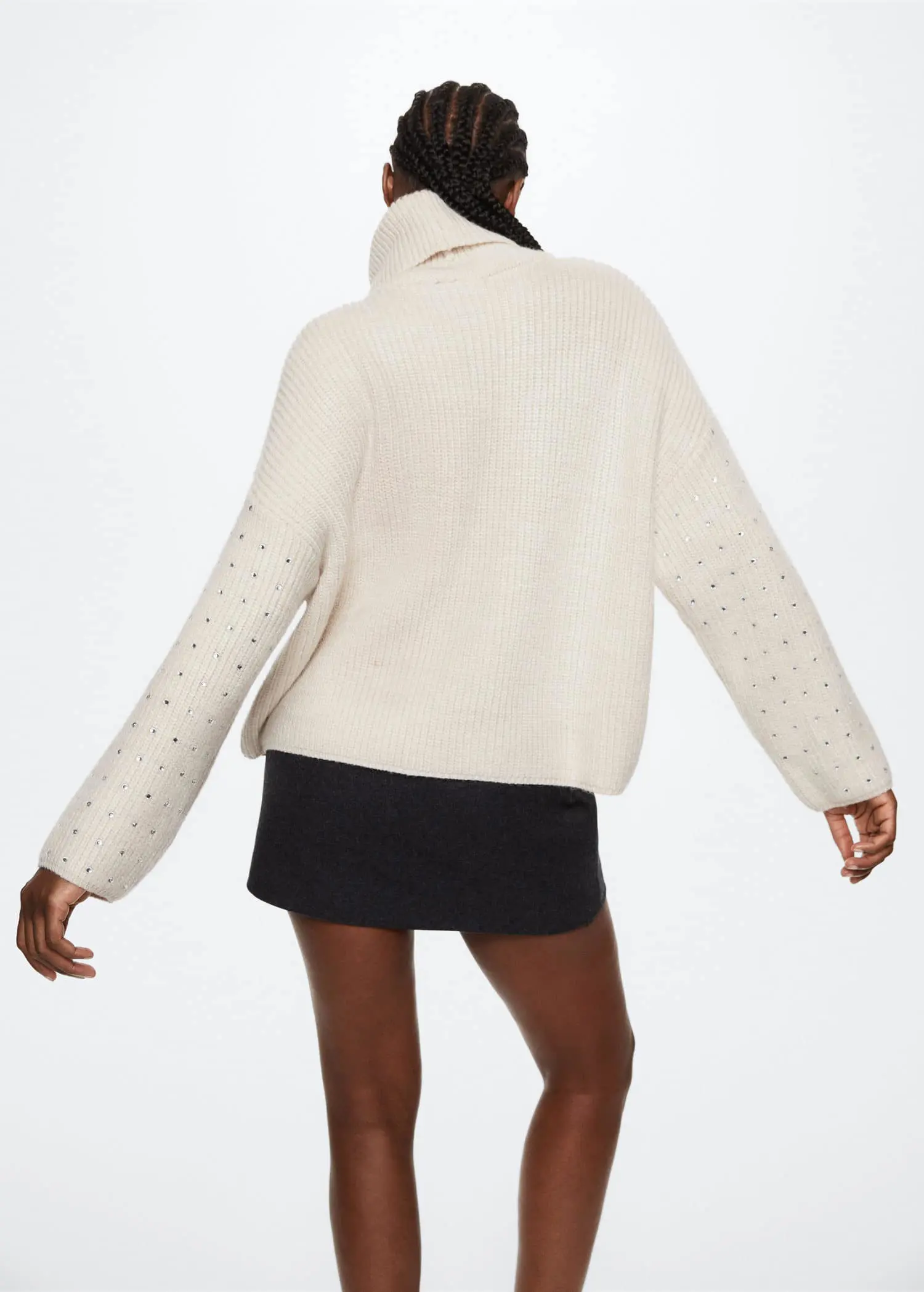 Mango Crystal detail sweatshirt. a woman wearing a white sweater and a black skirt. 