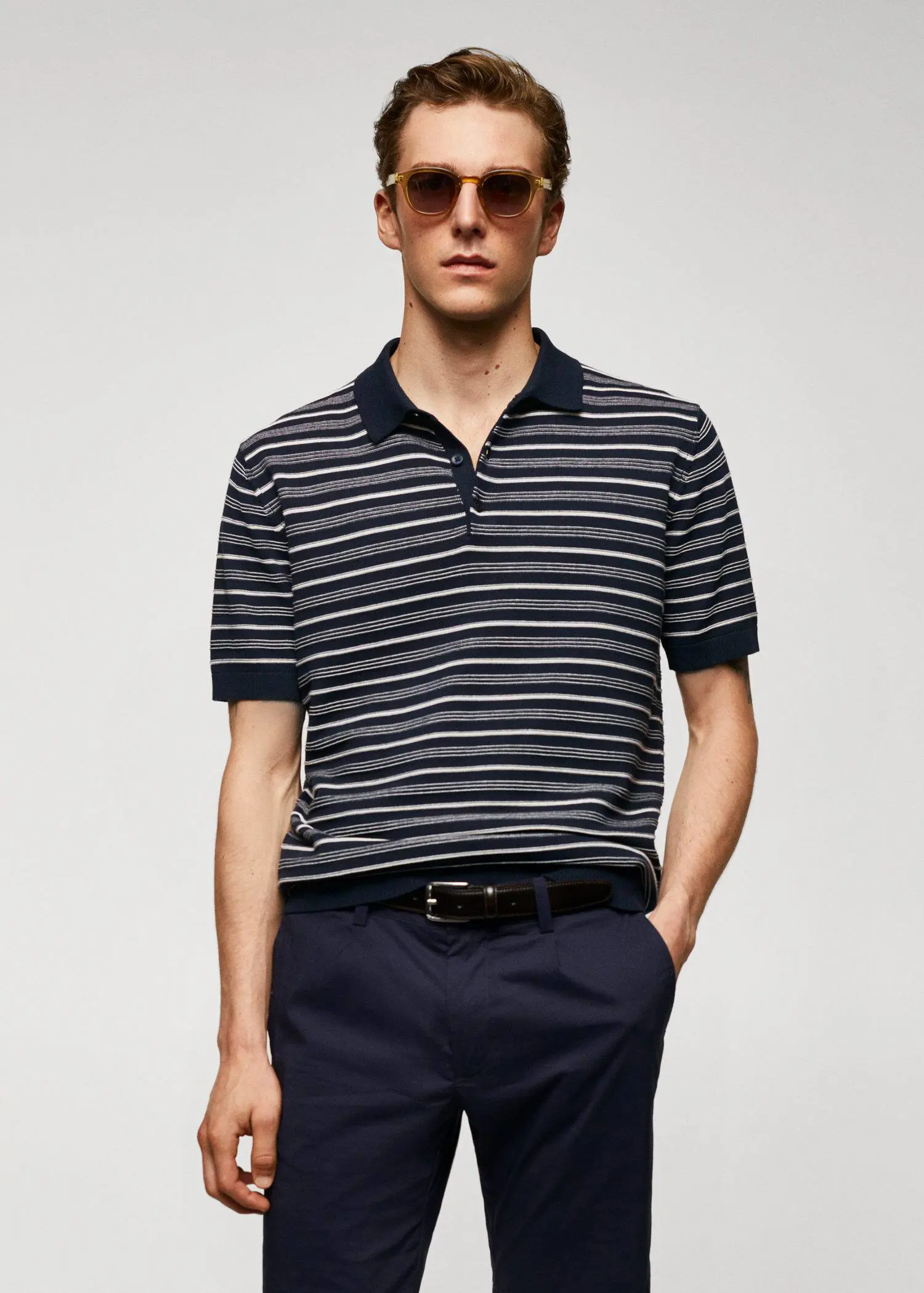 Mango Striped fine-knit polo shirt. a man in a striped polo shirt and sunglasses. 
