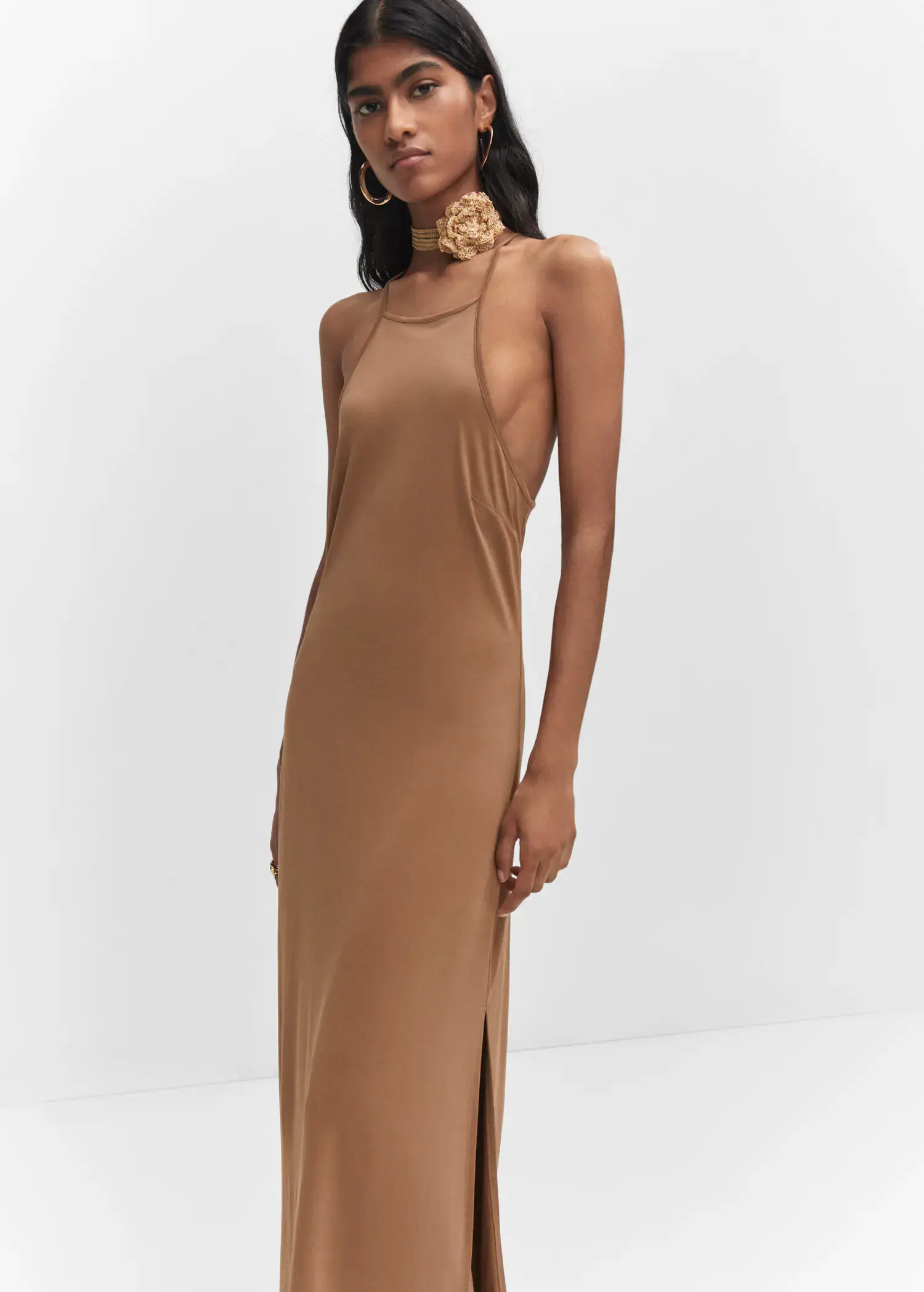Mango Halter-neck modal dress. a woman in a tan dress standing in front of a white wall. 