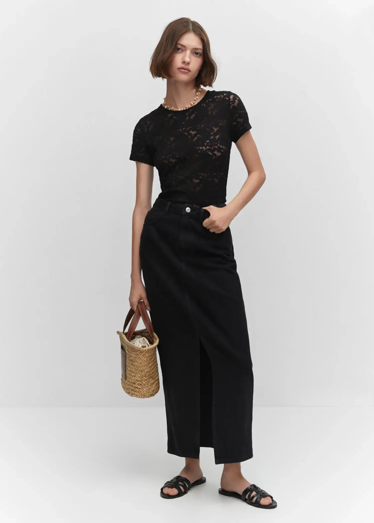Mango Guipure T-shirt. a woman in a black dress holding a straw bag. 