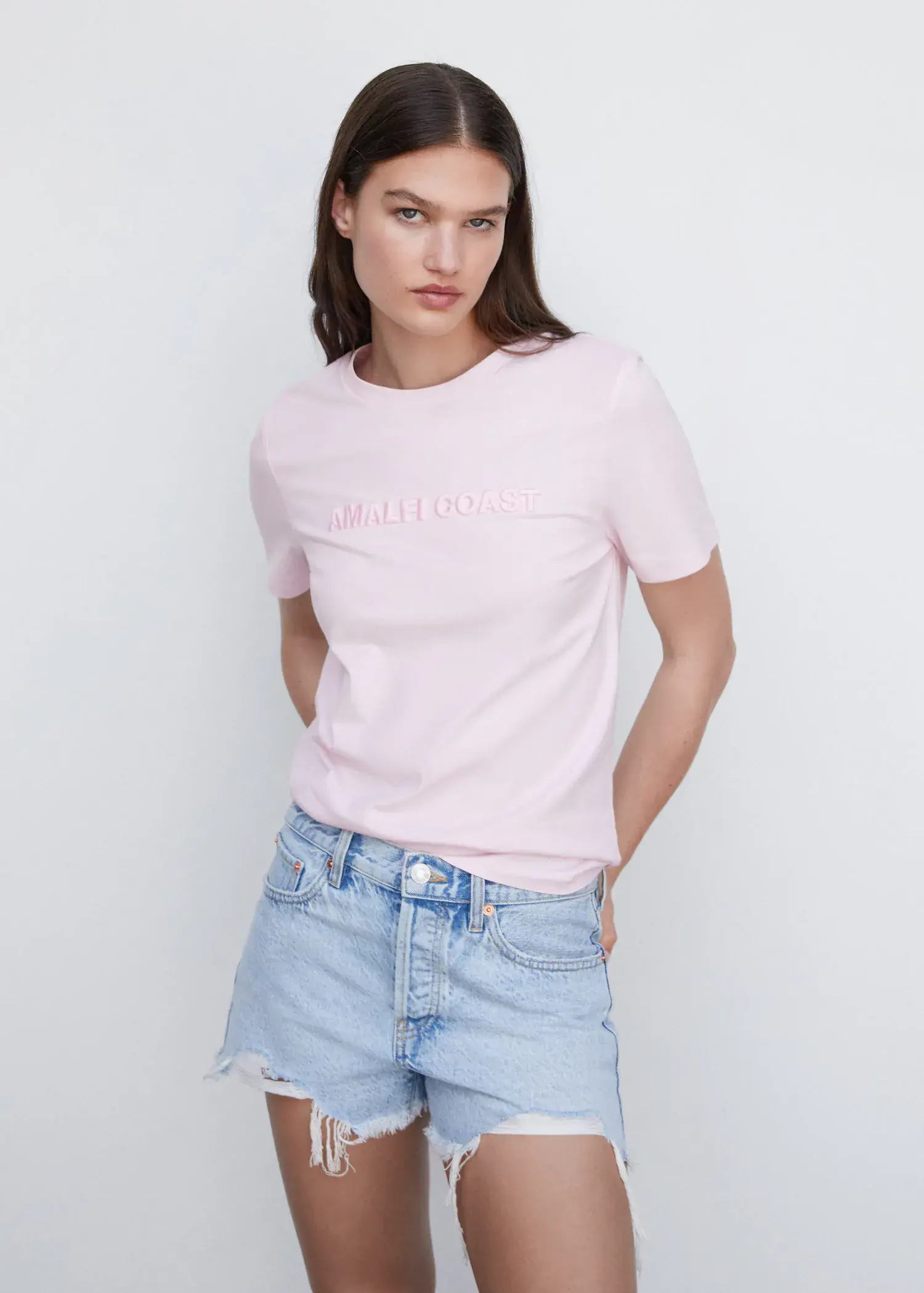 Mango Embroidered message T-shirt. a woman in a pink t-shirt and blue jean shorts. 