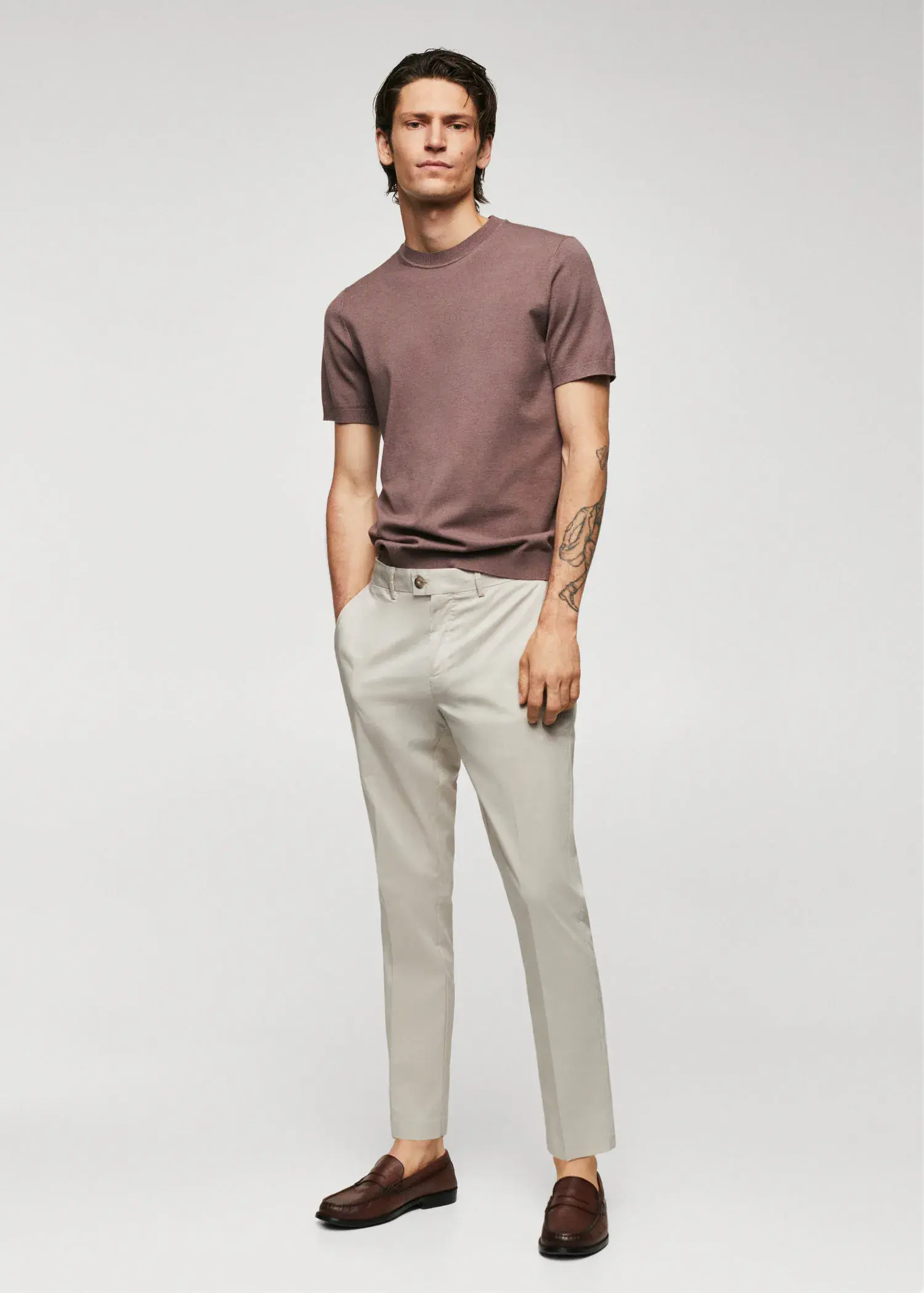 Mango Lightweight cotton trousers. a man in a brown shirt and white pants. 