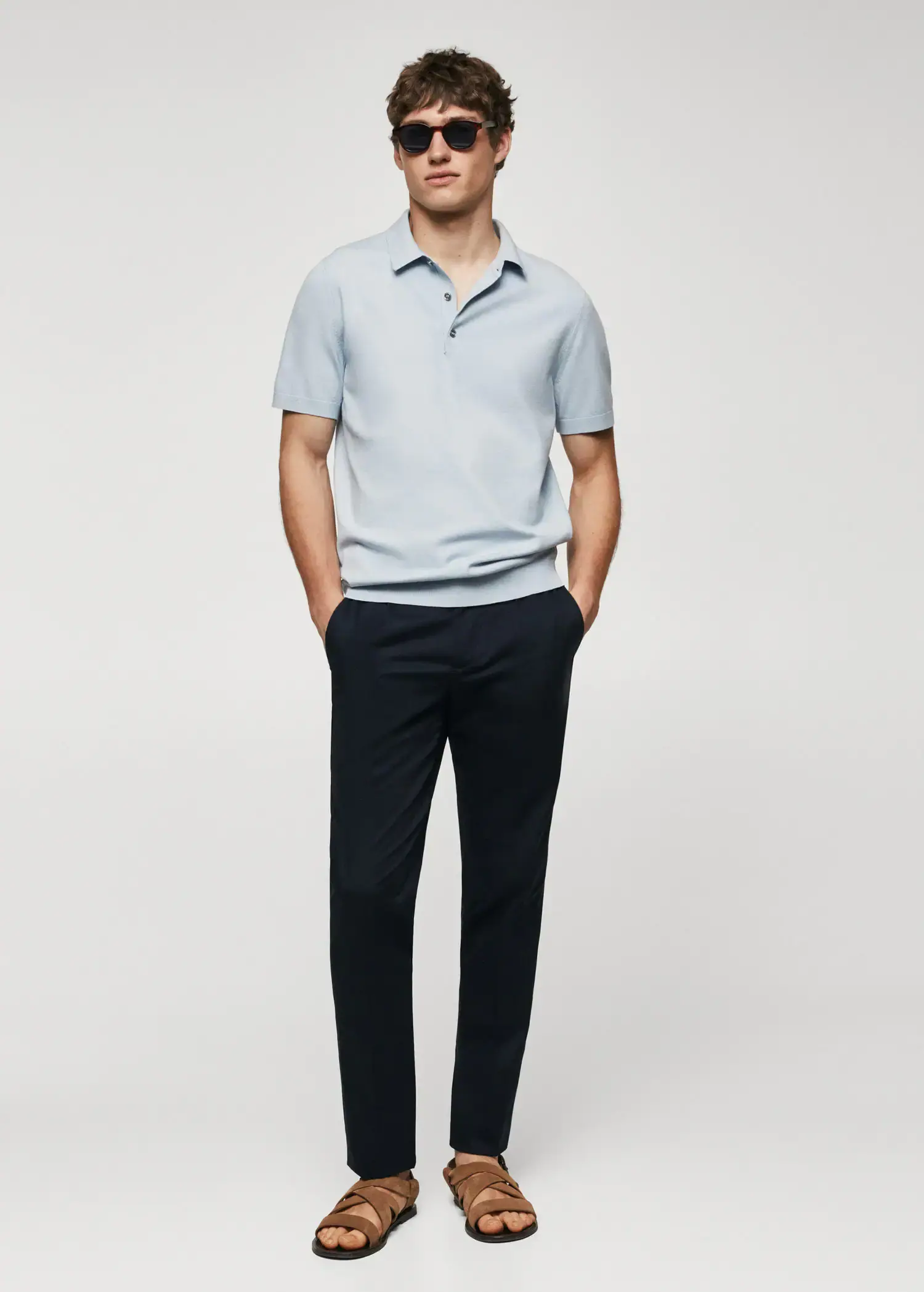 Mango Fine-knit polo shirt. a man standing in front of a white wall. 